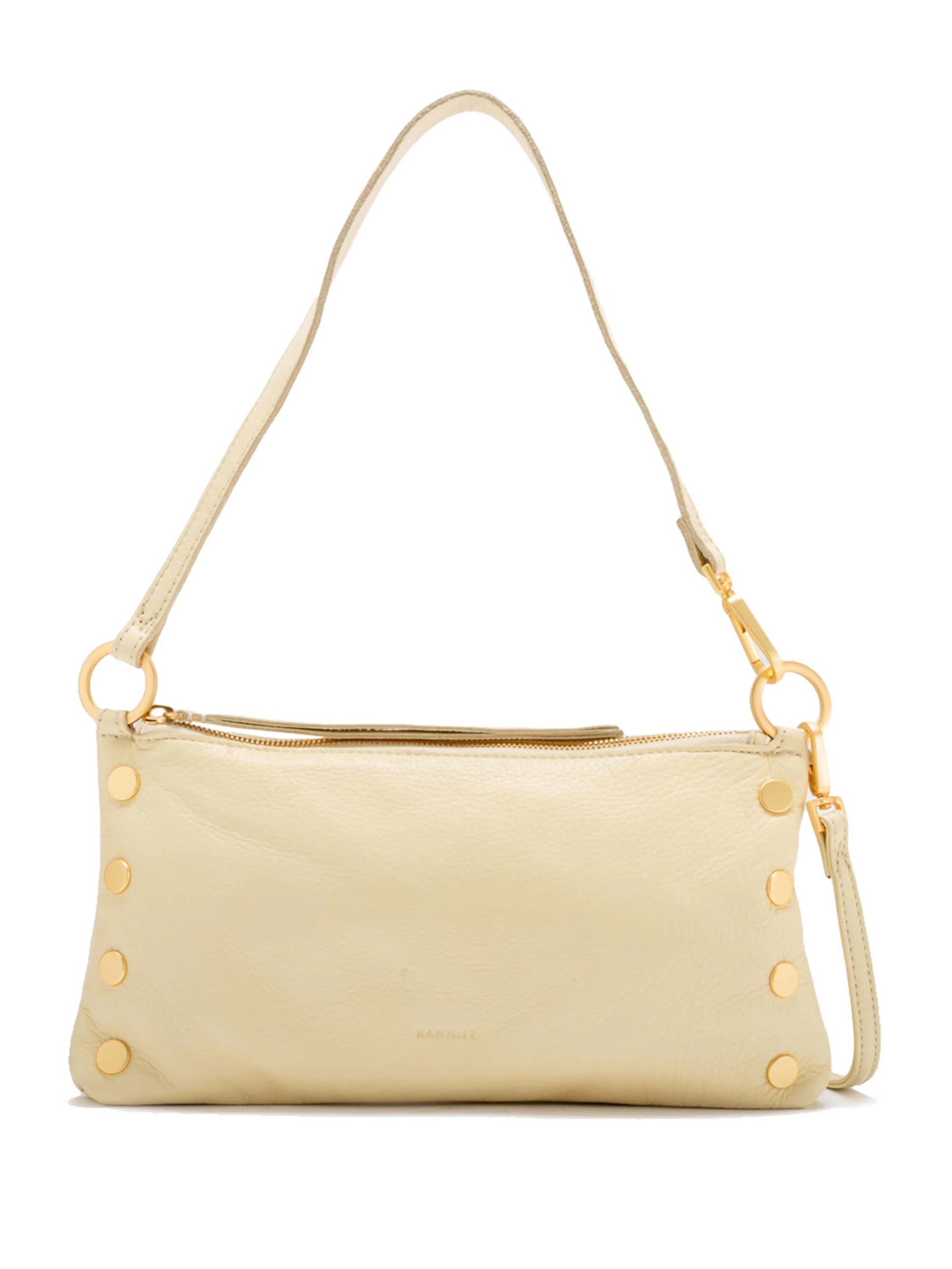 Cream pebbled leather shoulder bag with gold-toned top zipper and round studs along the bottom edge.