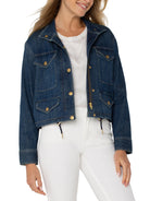 Cropped dark blue denim cargo jacket with gold zipper, snap buttons, four flap pockets, and drawstring waist.
