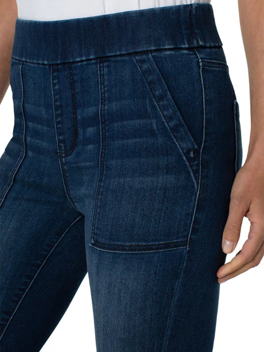 Dark wash blue denim pull-on pants with pockets. Elastic waistband.