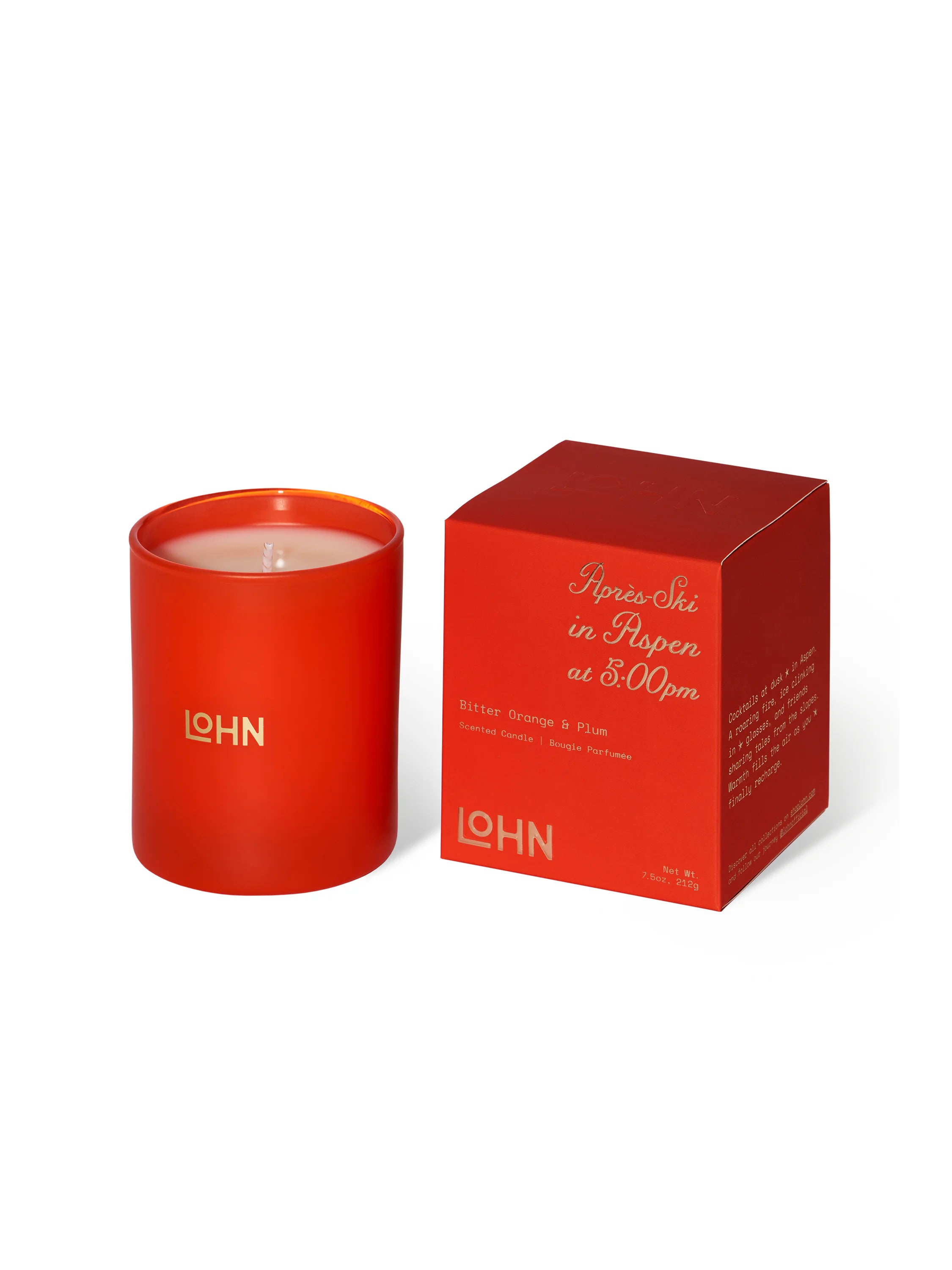Red cylindrical candle in a matching box. Off-white wax, gold logo.