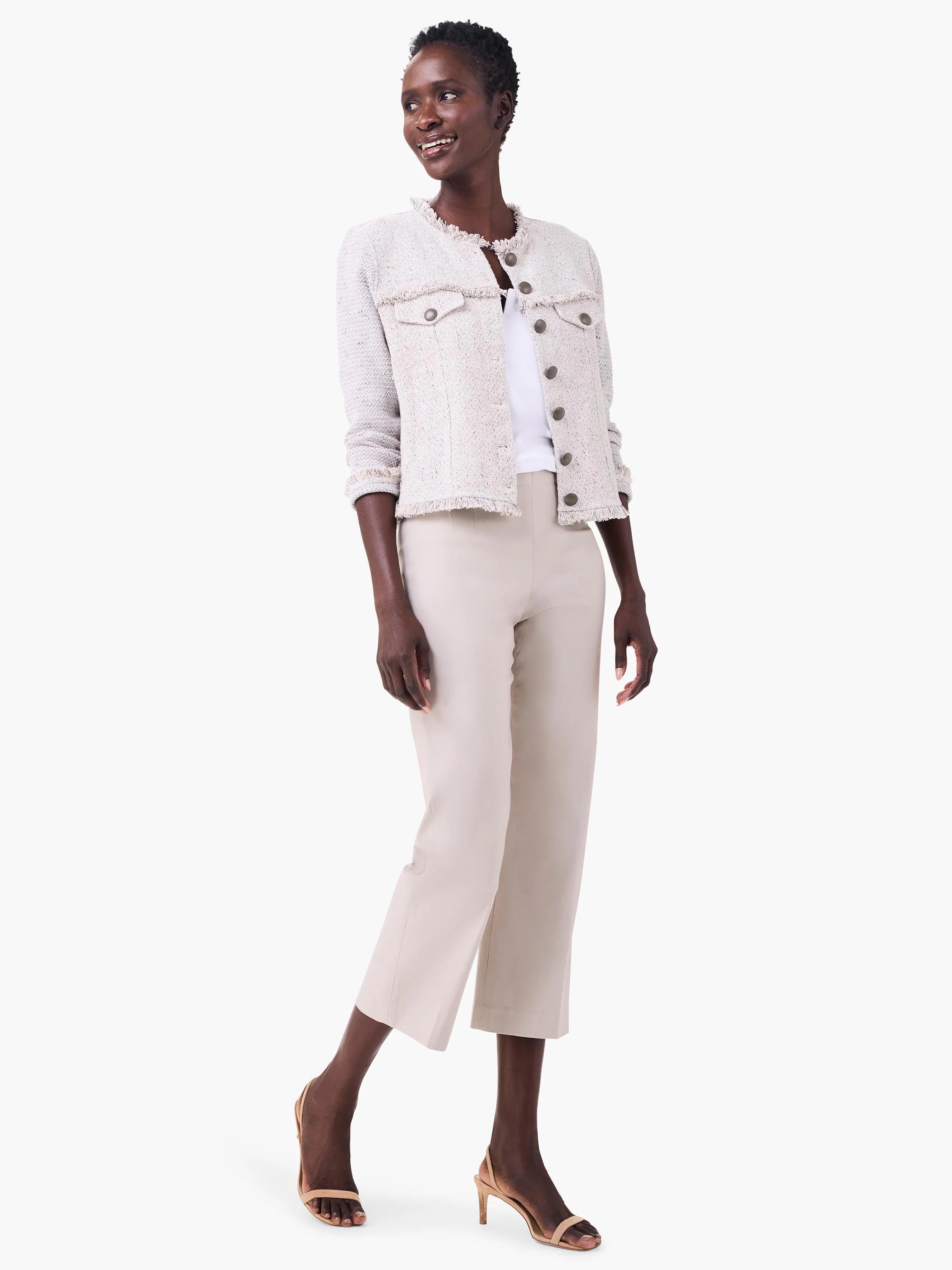 White jersey split neck tank, partially visible on a model underneath a light-colored jacket.