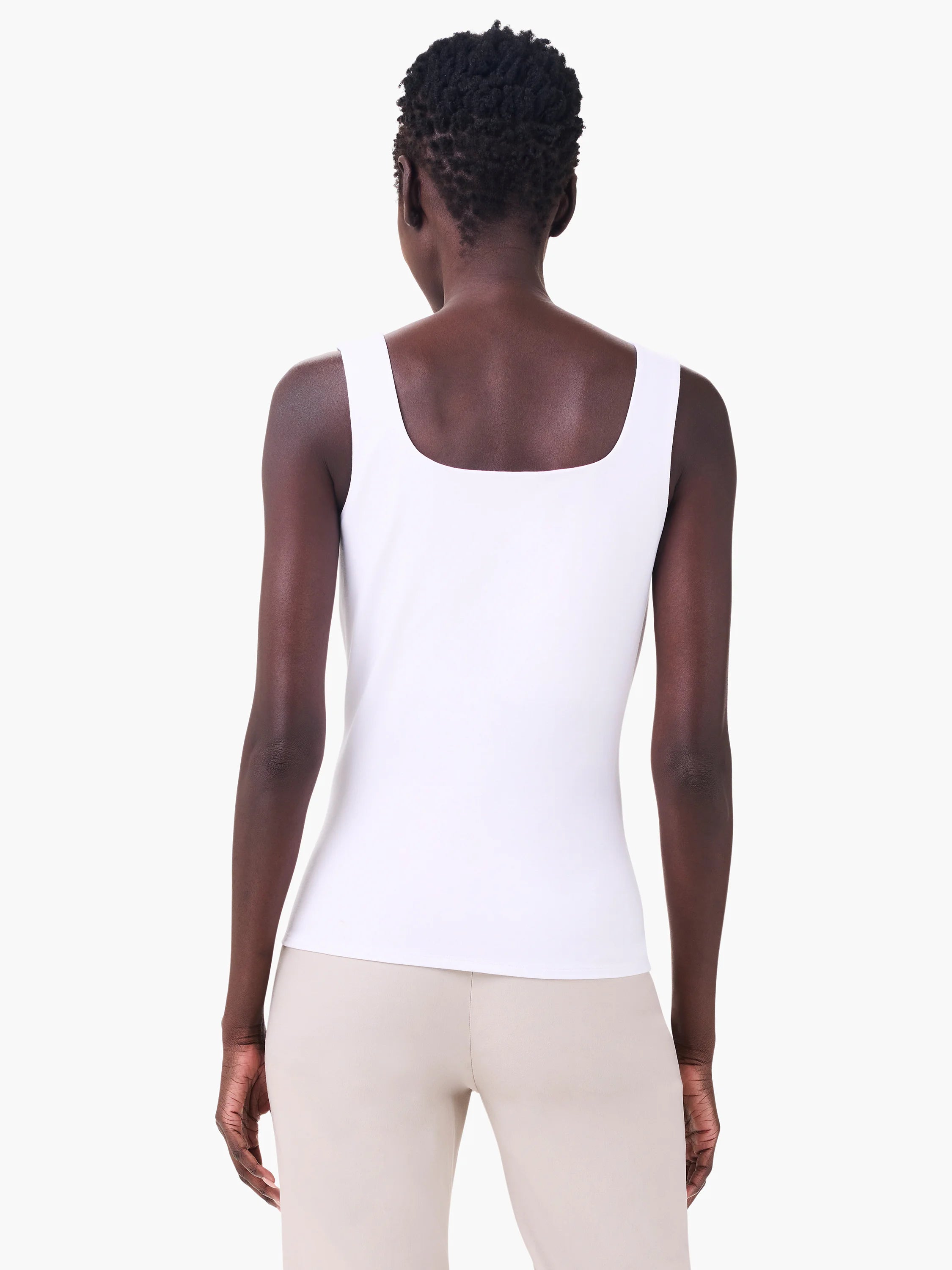White jersey tank top with square back neckline, worn by a model facing away.