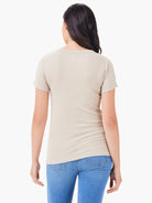 Back view of a light tan, ribbed knit, short-sleeve crew neck tee, fitted on a model.