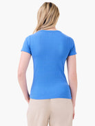 Rear view of a bright blue ribbed short-sleeve crew tee worn by a person.