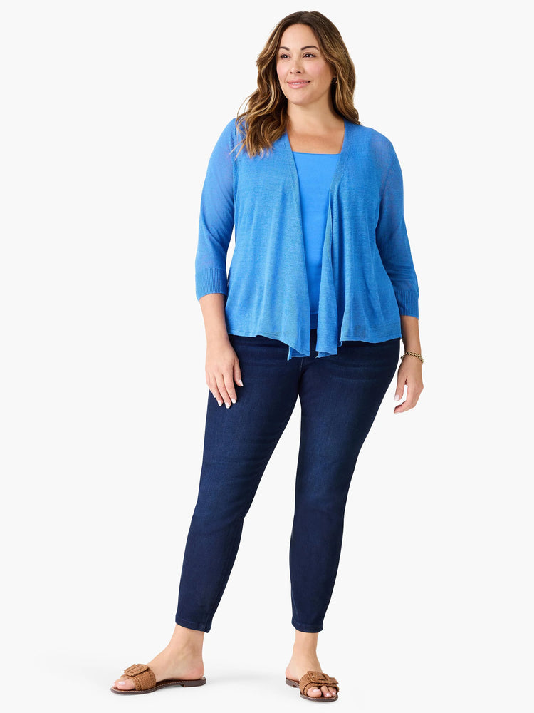 Blue square neck tank top on a model, featuring wide straps and a smooth, medium blue fabric.