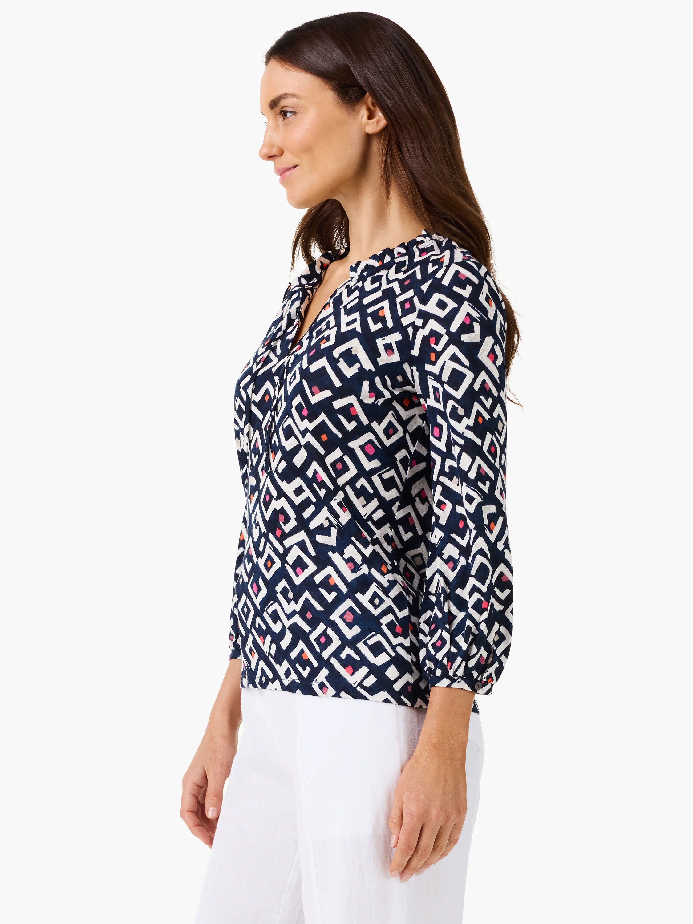 Indigo V-neck top with white geometric angled pattern, accented by pink & orange shapes. 3/4 gathered sleeves.