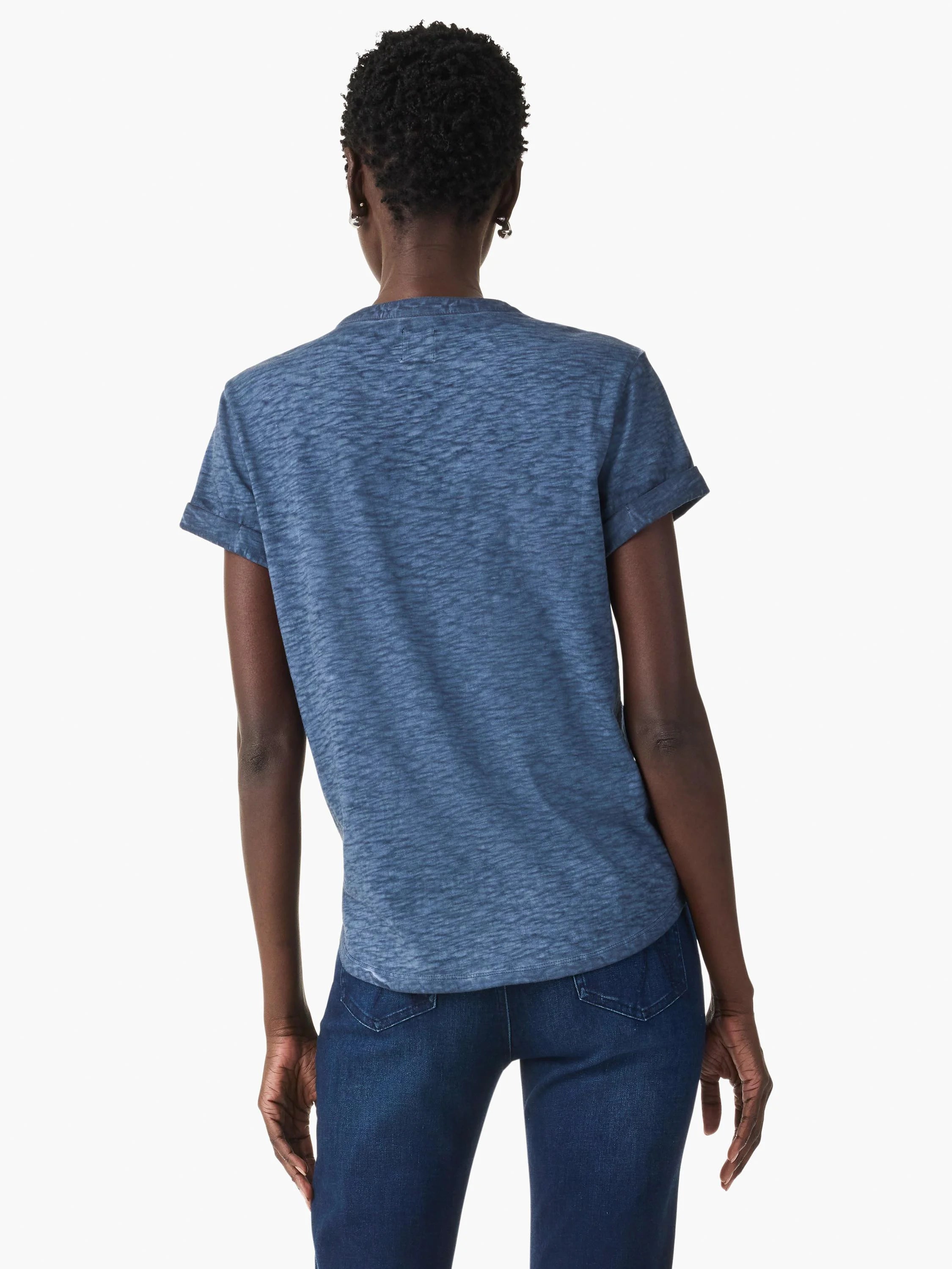 Back view of model in mottled blue top. Features a relaxed fit and short, cuffed sleeves.