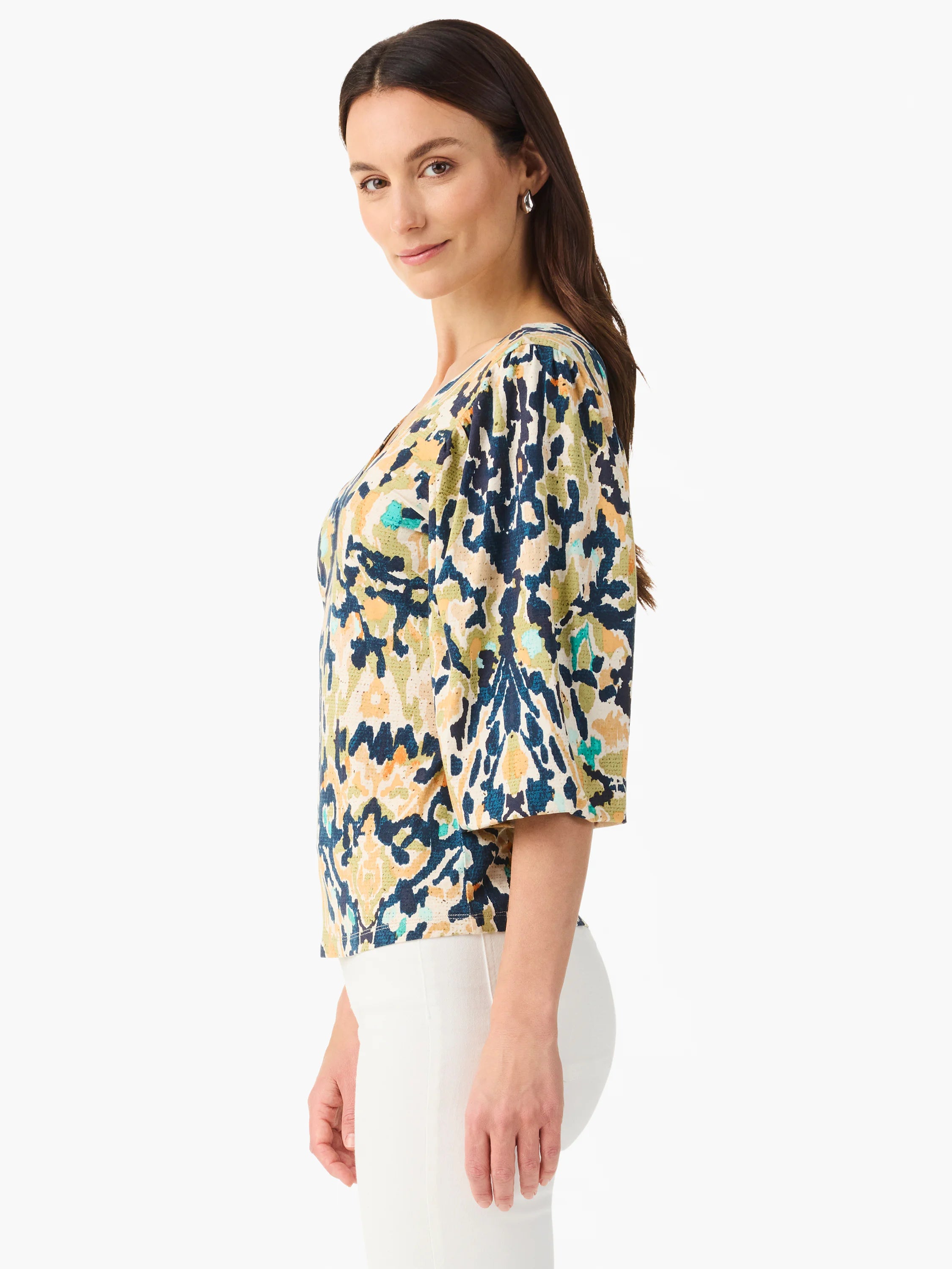 V-neck top with abstract pattern in navy, olive, beige, orange, and teal. Features 3/4 length gathered sleeves.