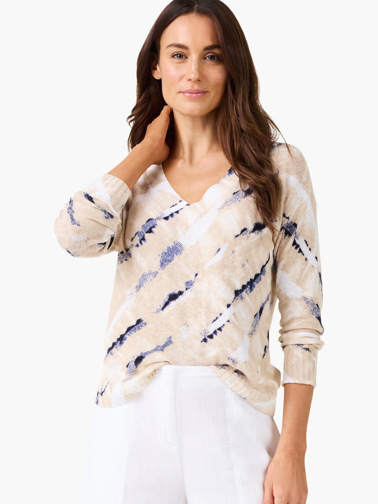 Cream, white, and dark blue abstract striped V-neck sweater.