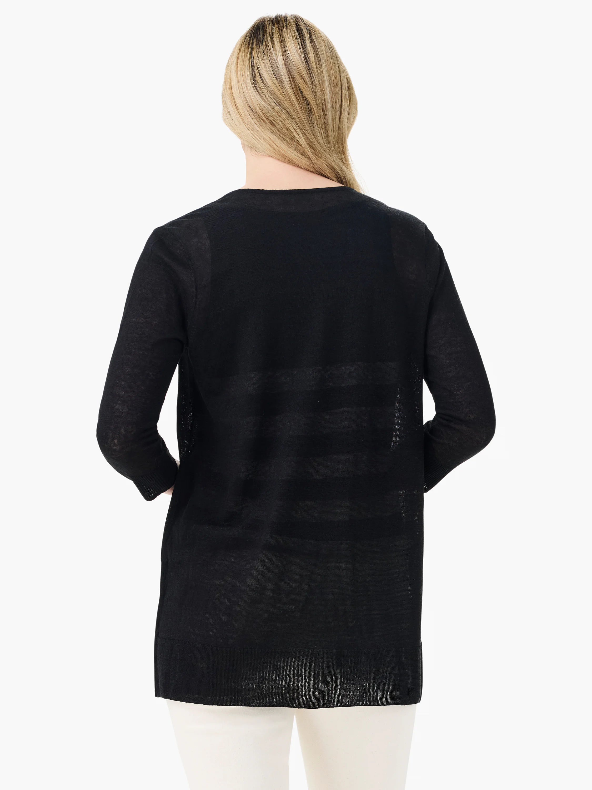 Black sheer long-sleeve cardigan with ribbed cuffs, extending past hips, worn from behind over light pants.
