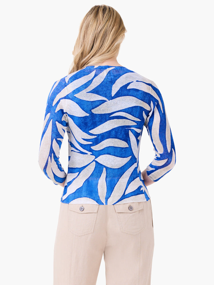 Blue and off-white cardigan with an abstract leaf pattern, shown from the back on a model.