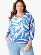 Blue and white cardigan with abstract leaf pattern, V-neck, and 3/4 sleeves.