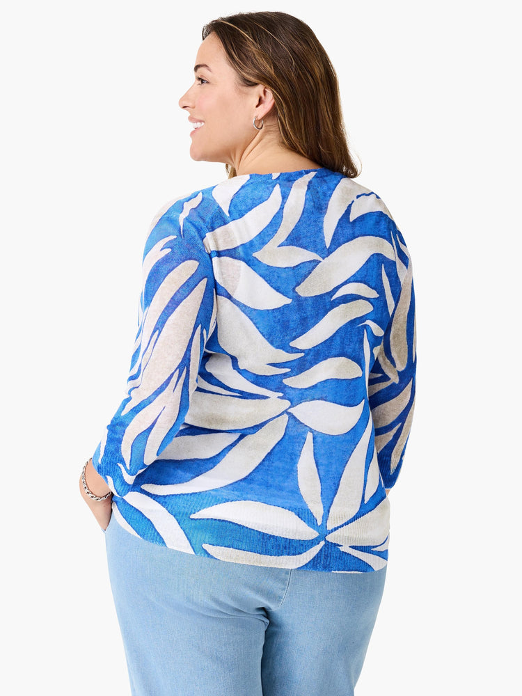 Blue and off-white cardigan with an abstract leaf pattern.