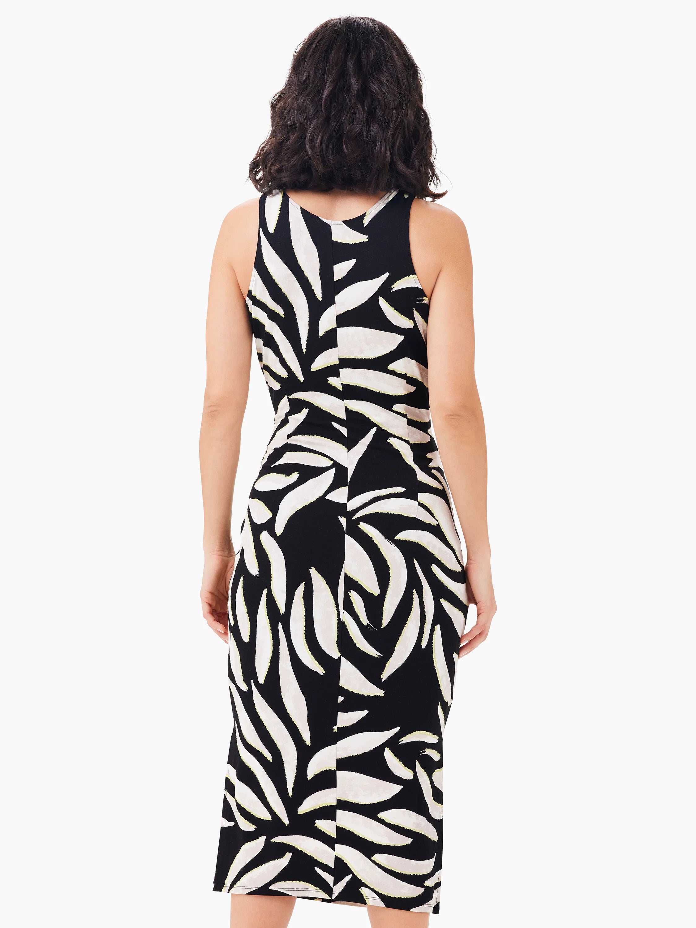 Black sleeveless fitted dress with a cream leaf print. Model shown from back.