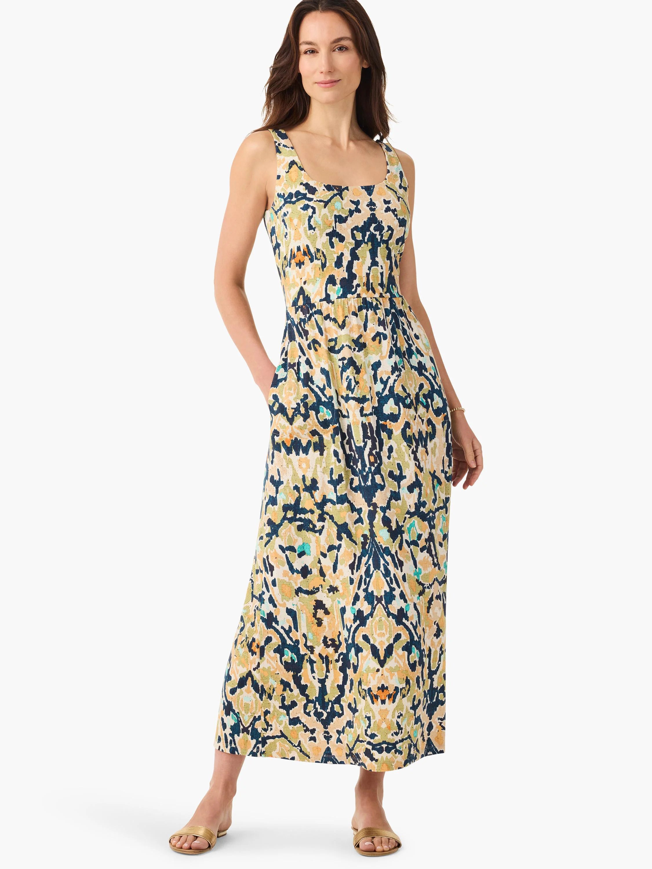 Sleeveless maxi dress with square neck, side pockets, and an abstract pattern in cream, navy, olive green, and gold.