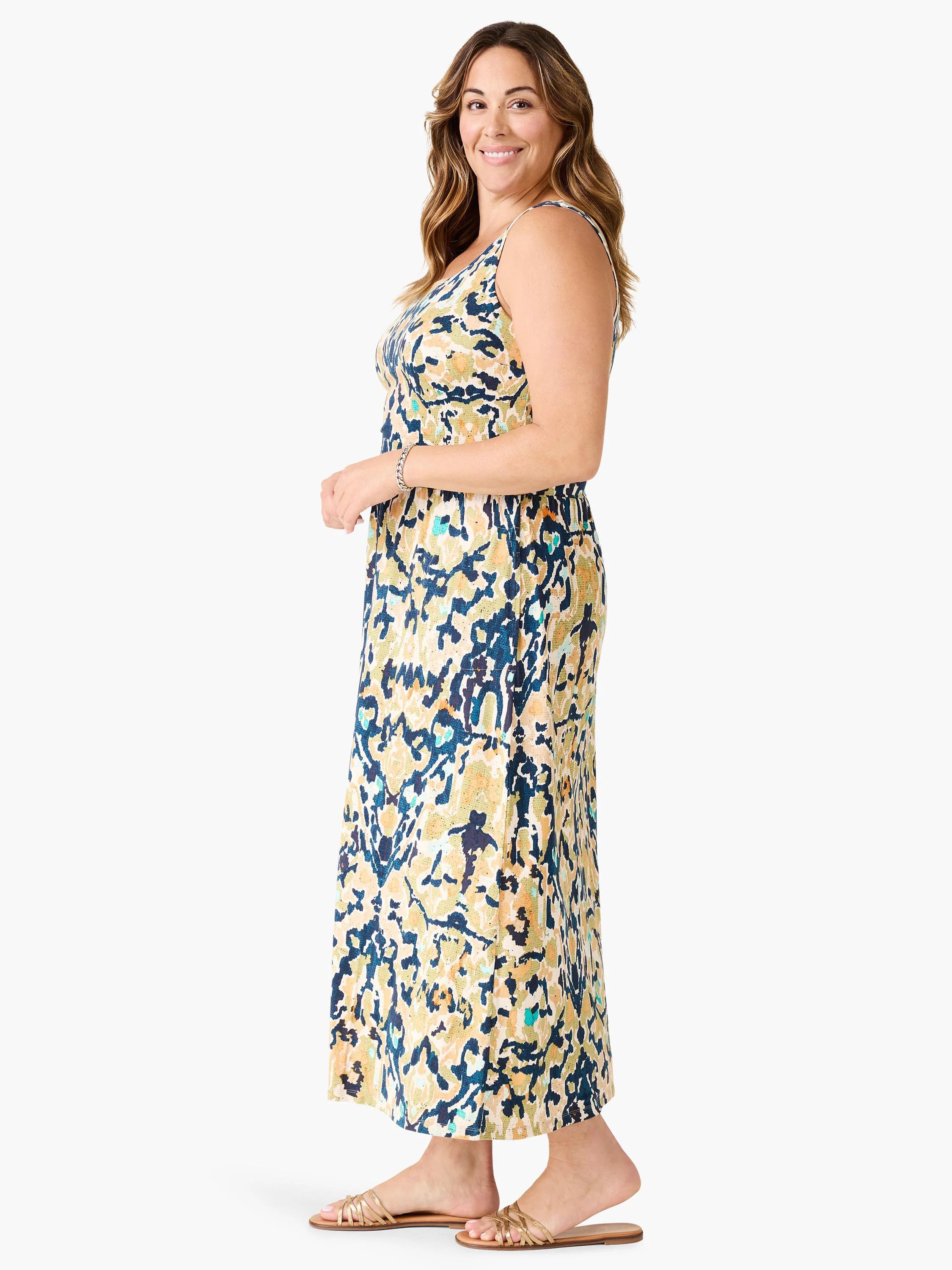 Sleeveless maxi dress with abstract print in cream, navy, golden yellow, and teal. Relaxed silhouette.