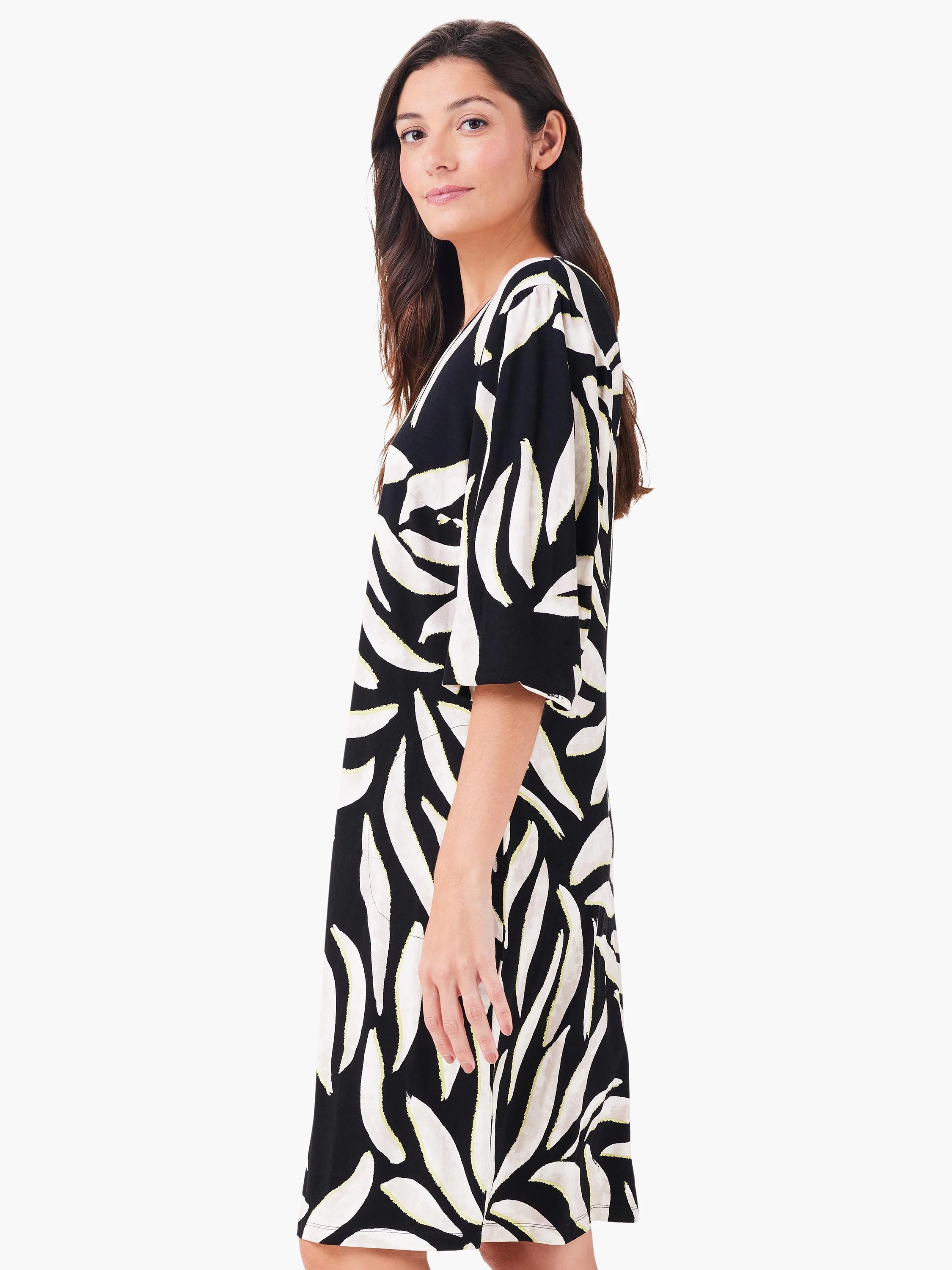 Black V-neck dress with cream, lime-accented abstract leaf pattern.