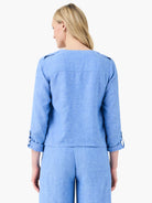 Light blue linen jacket, back view. Features shoulder epaulets and cuffed 3/4 sleeves with tabs.