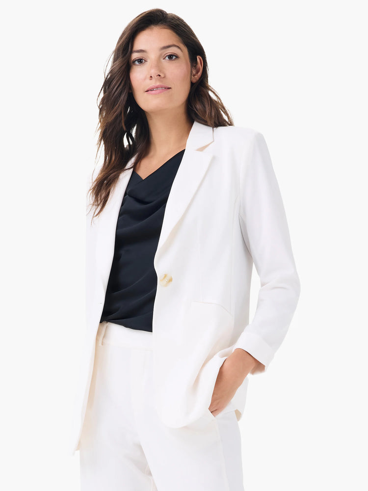 White blazer with notched lapels, two cream buttons, and structured cuffs.