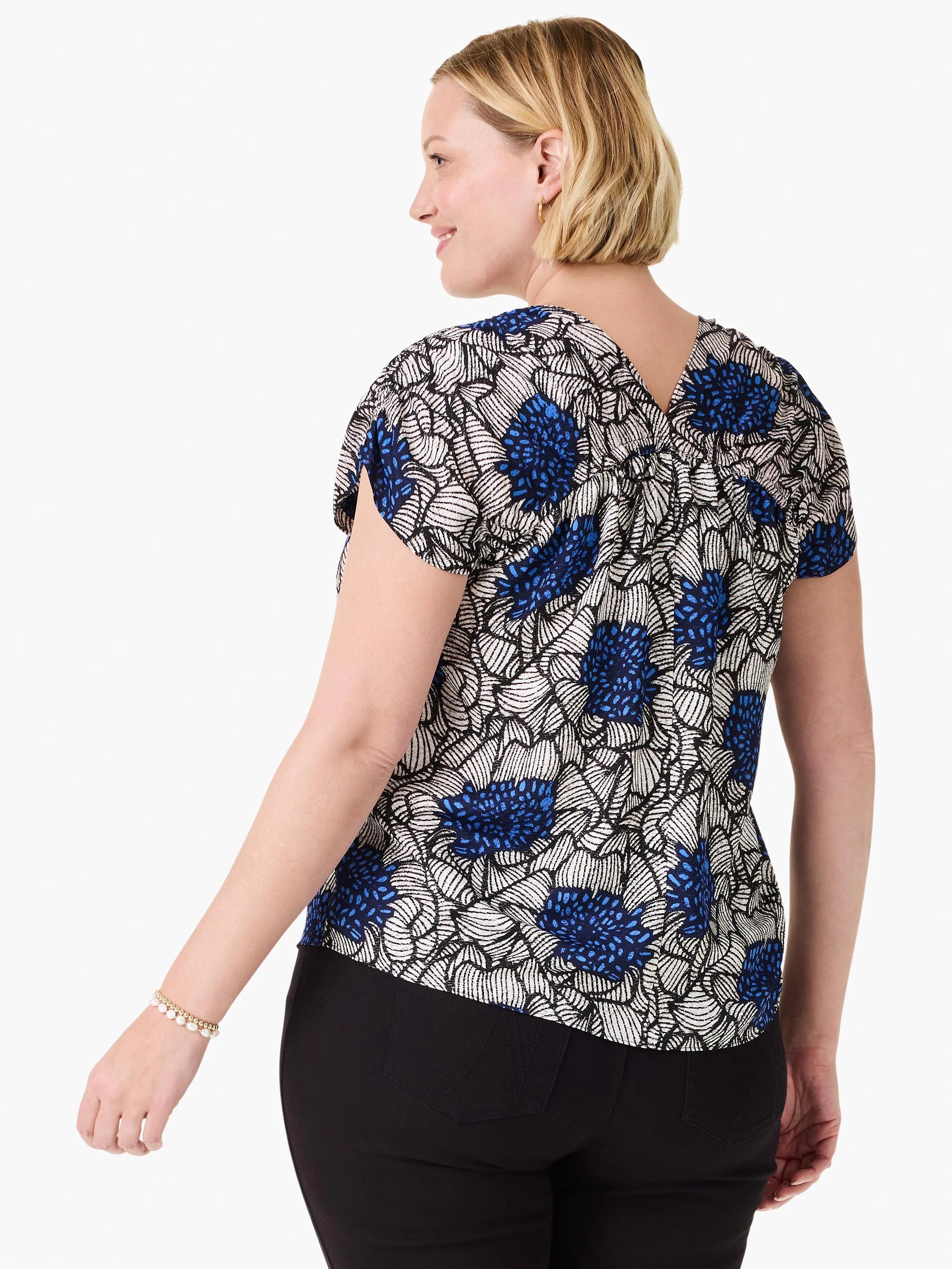 Blue, white, & black floral print top with short cap sleeves & V-neck back.