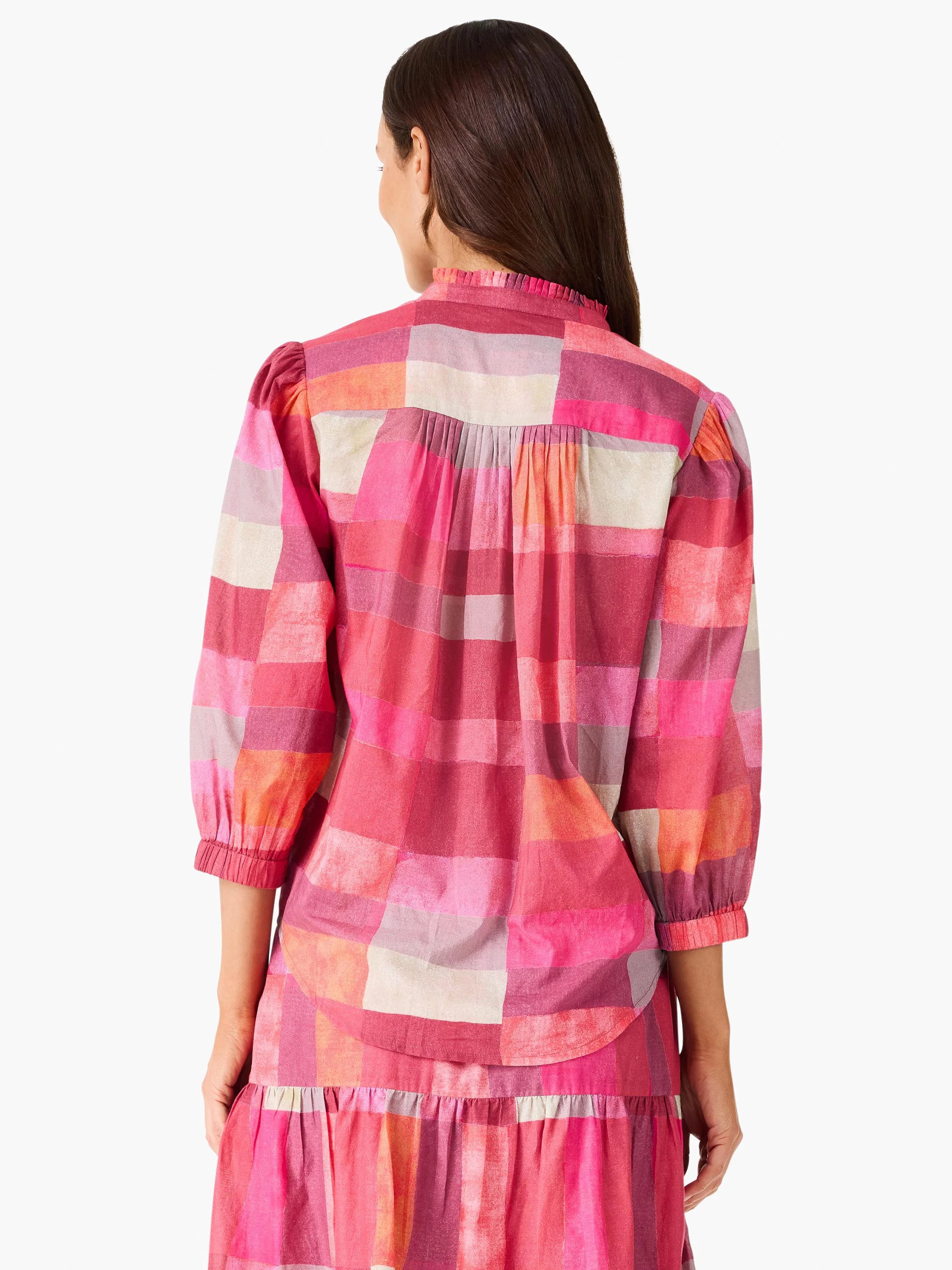 Pink, coral, fuchsia plaid shirt, back view. Ruffled collar, puffed 3/4 sleeves, gathered cuffs, and pleated back yoke.