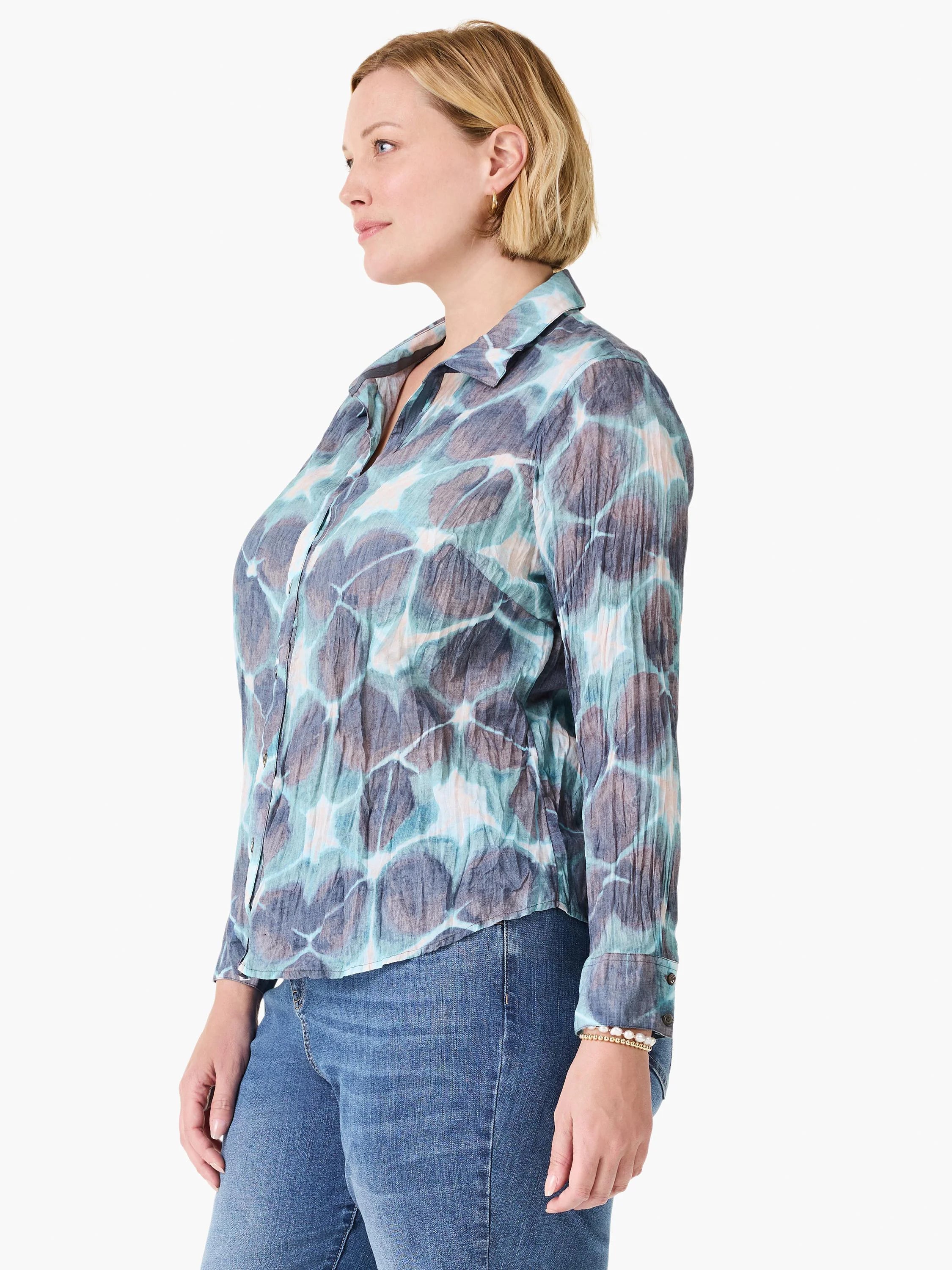 Crinkled button-up shirt in teal, indigo, and taupe abstract pattern with cream highlights.