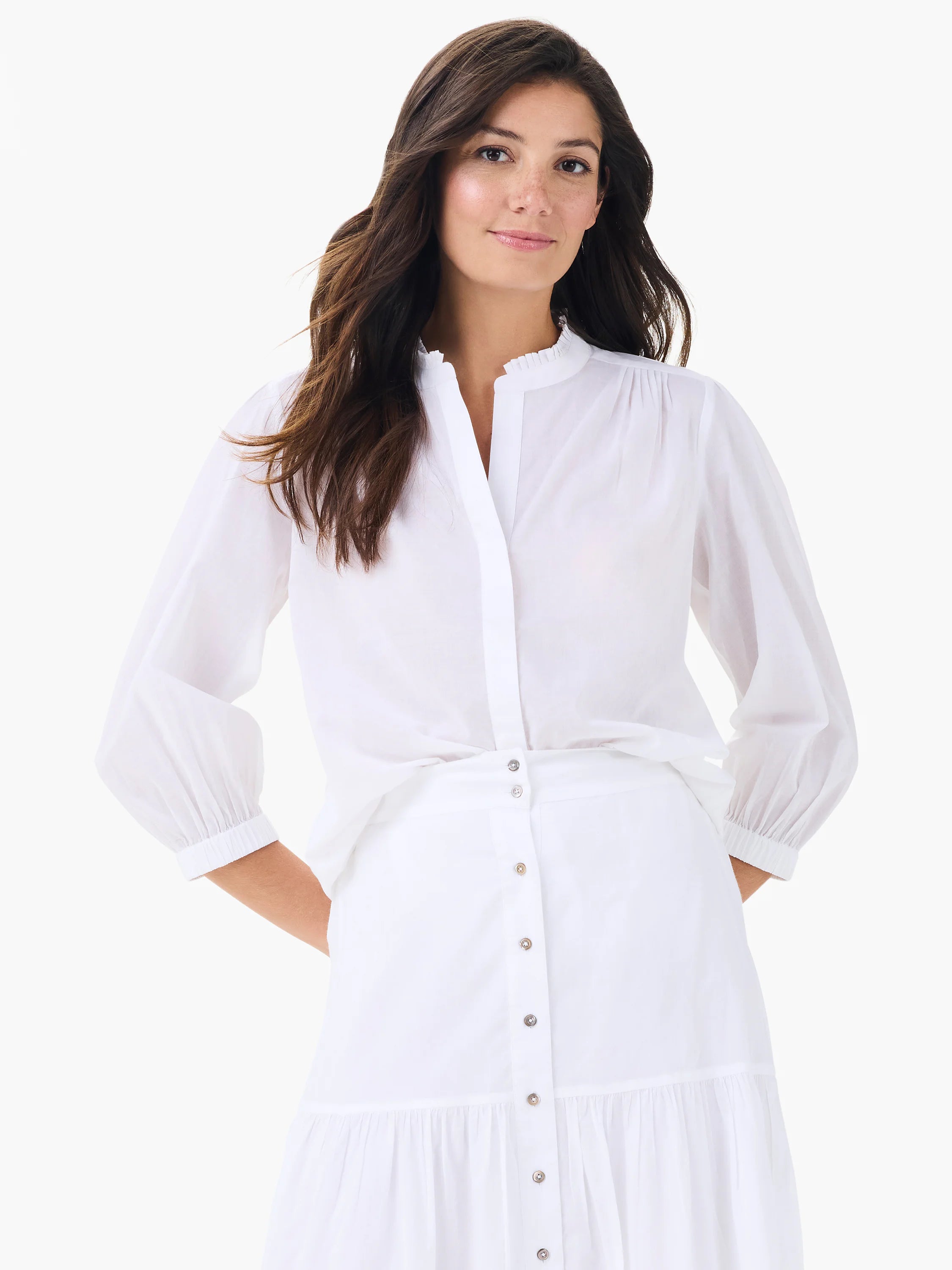 White cotton shirt with ruffled stand collar, split V-neck, and long sleeves with gathered elastic cuffs.