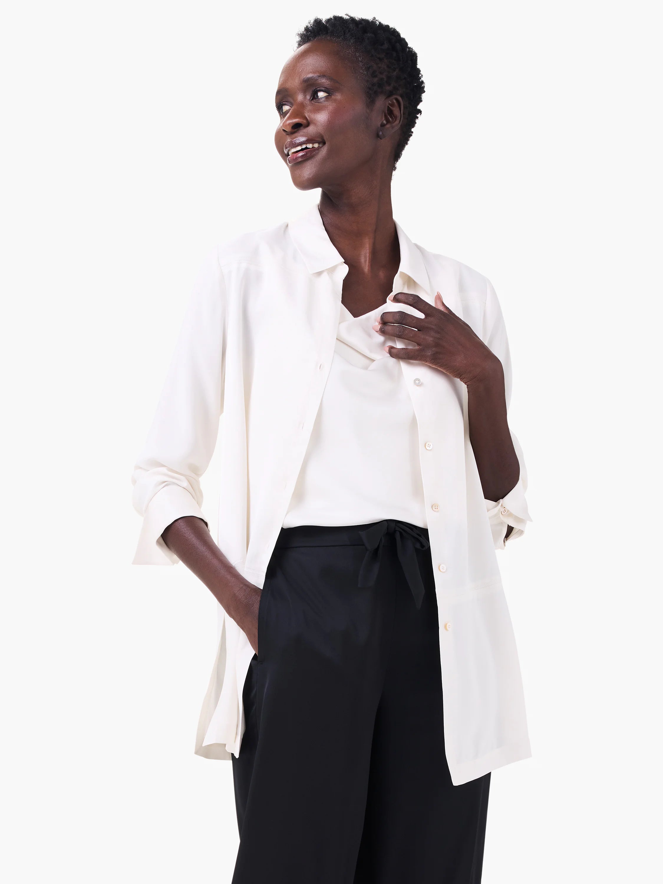 Cream collared shirt, open with cuffed long sleeves, layered over a matching camisole.