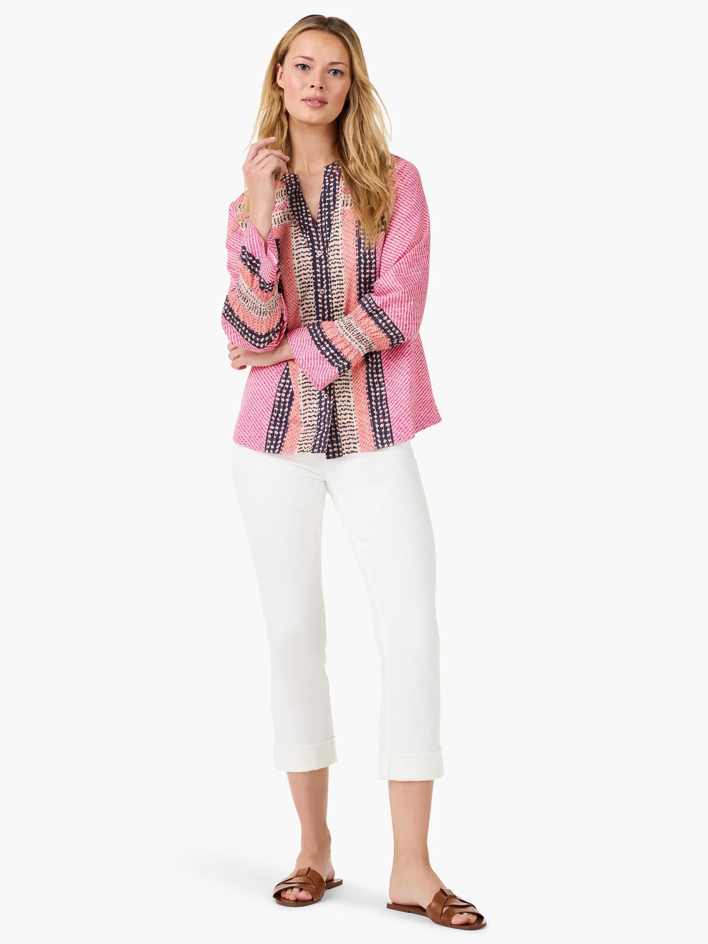 Pink long-sleeve top with vertical navy and peach dotted stripes, button-front closure.