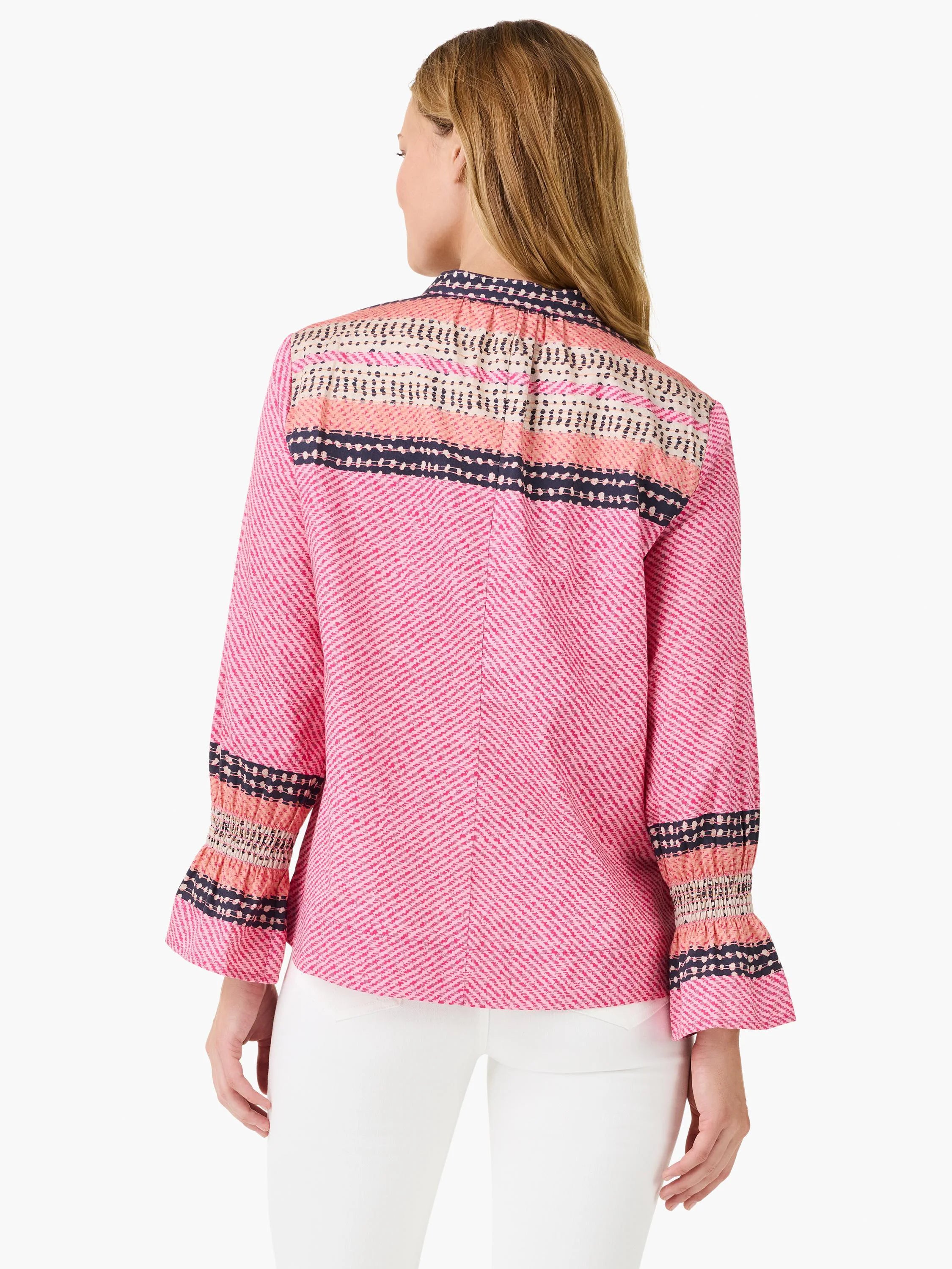 Pink top with herringbone texture. Yoke and smocked cuffs feature navy dotted stripes and peach-pink stripes.