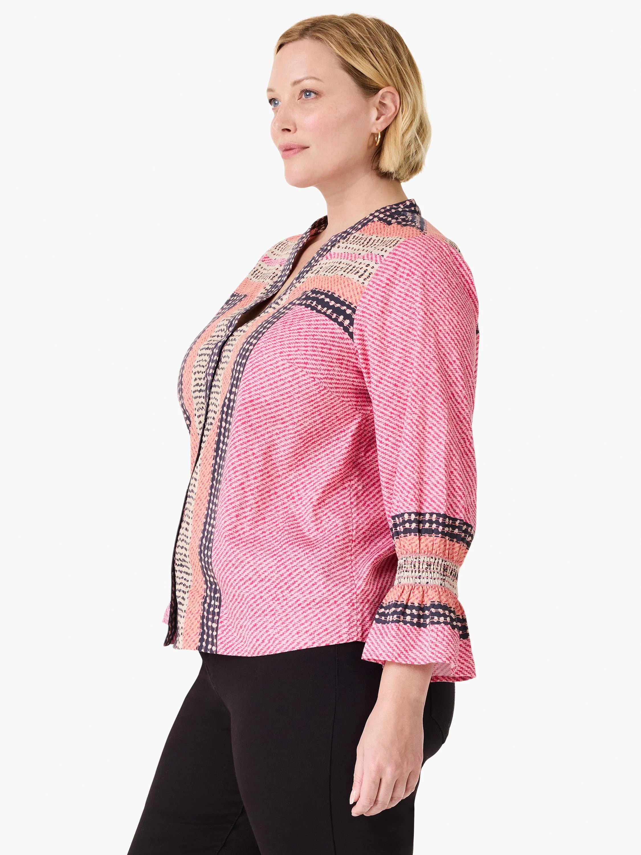 Pink V-neck top with diagonal stripes. Features navy spotted and beige striped trim on front placket and shirred 3/4 cuffs.