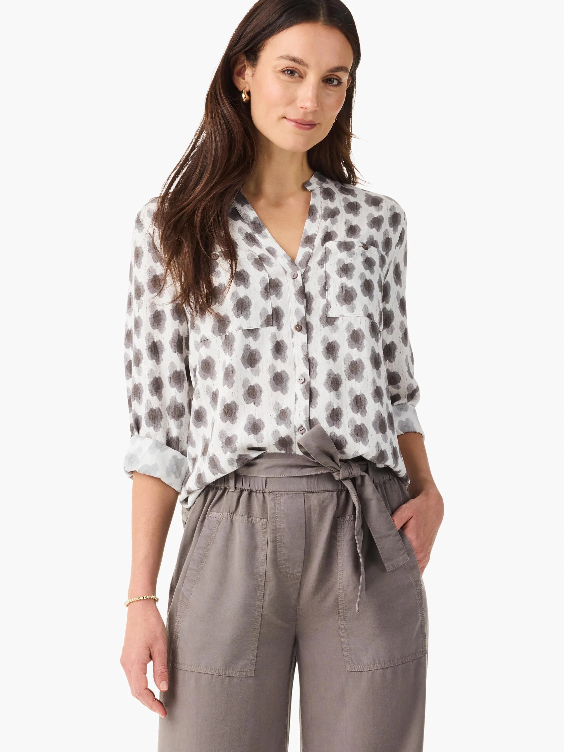 White button-down shirt featuring a scattered dark grey clover stamp pattern, V-neck, rolled sleeves, and chest pockets.