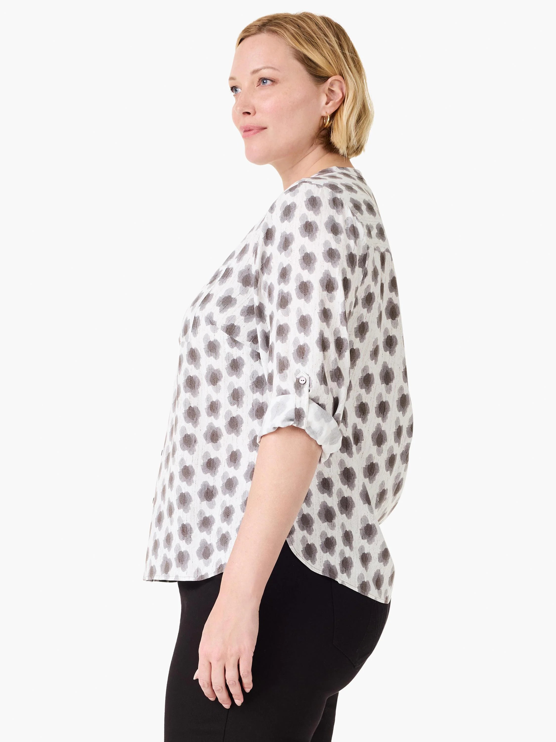 White blouse with a gray clover stamp pattern. Features rolled-up sleeves secured by tabs.