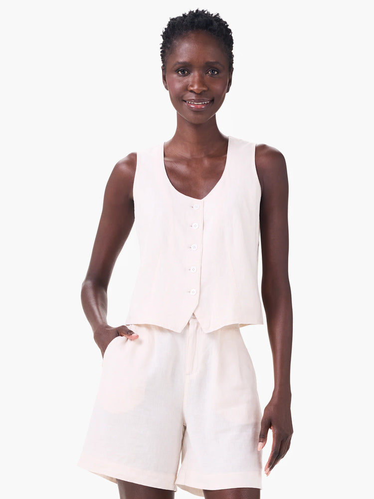 Off-white linen vest, sleeveless, button front. Model wears matching shorts.
