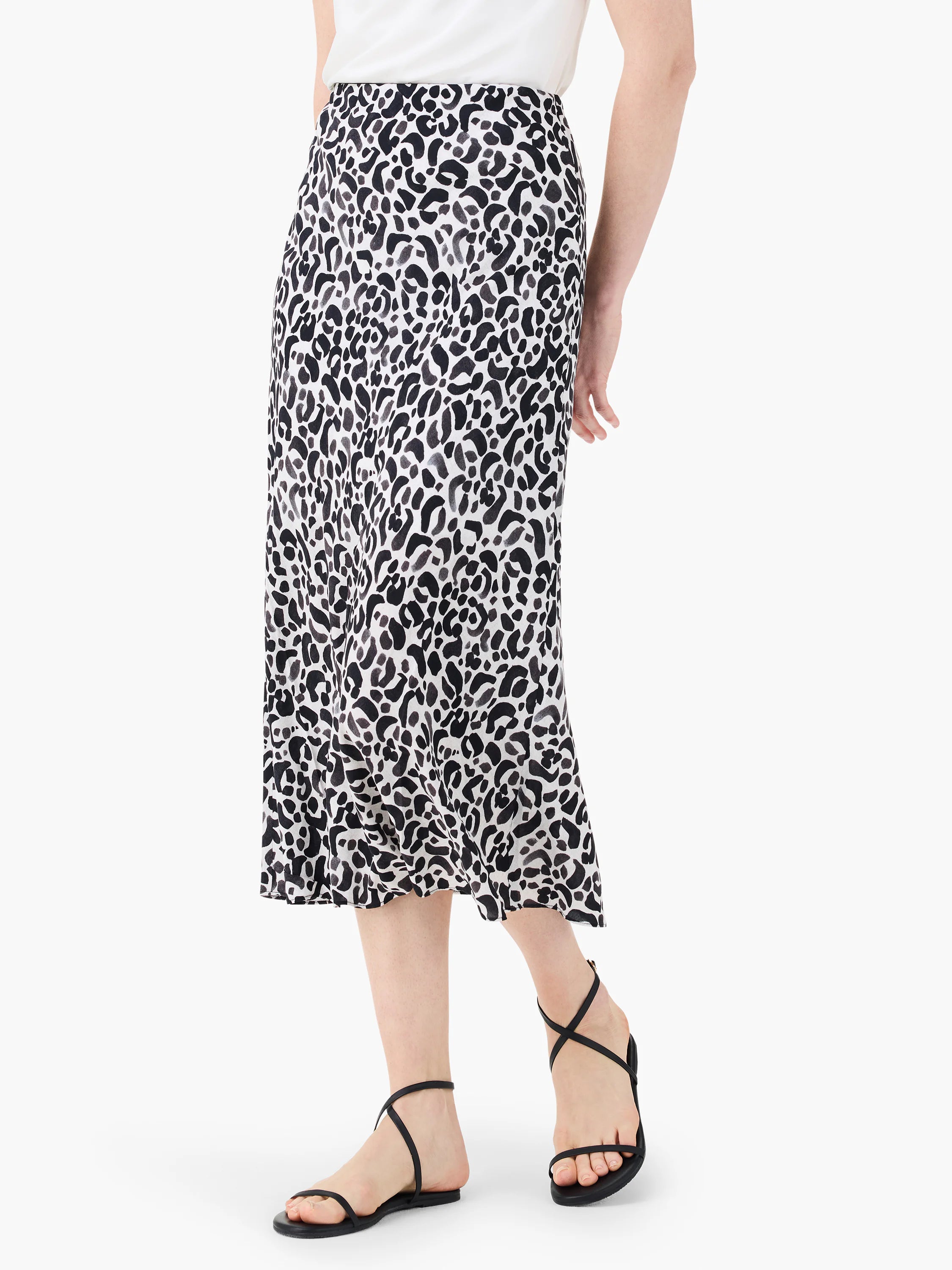 Mid-length slip skirt in black and gray leopard print on off-white background.