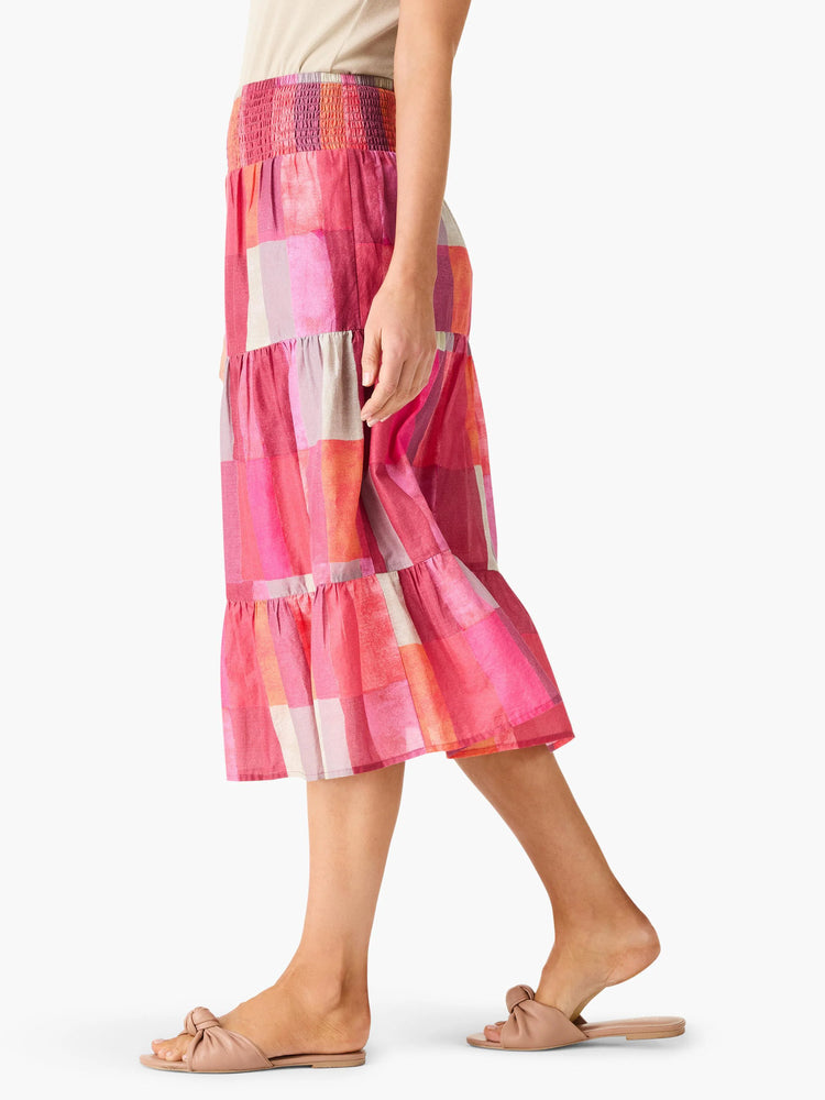 Mid-length tiered skirt in pink, orange, and gray plaid pattern. Elastic waistband.