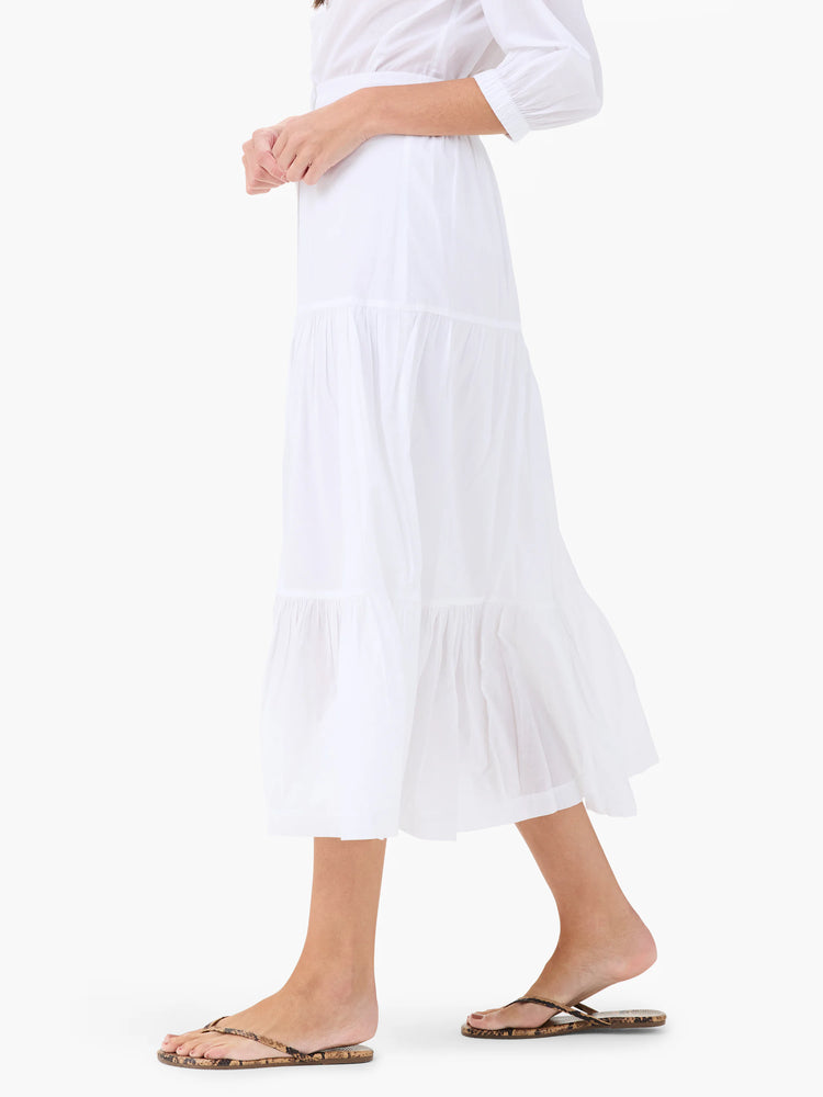 White cotton tiered midi skirt. Features multiple ruffles at the hem.