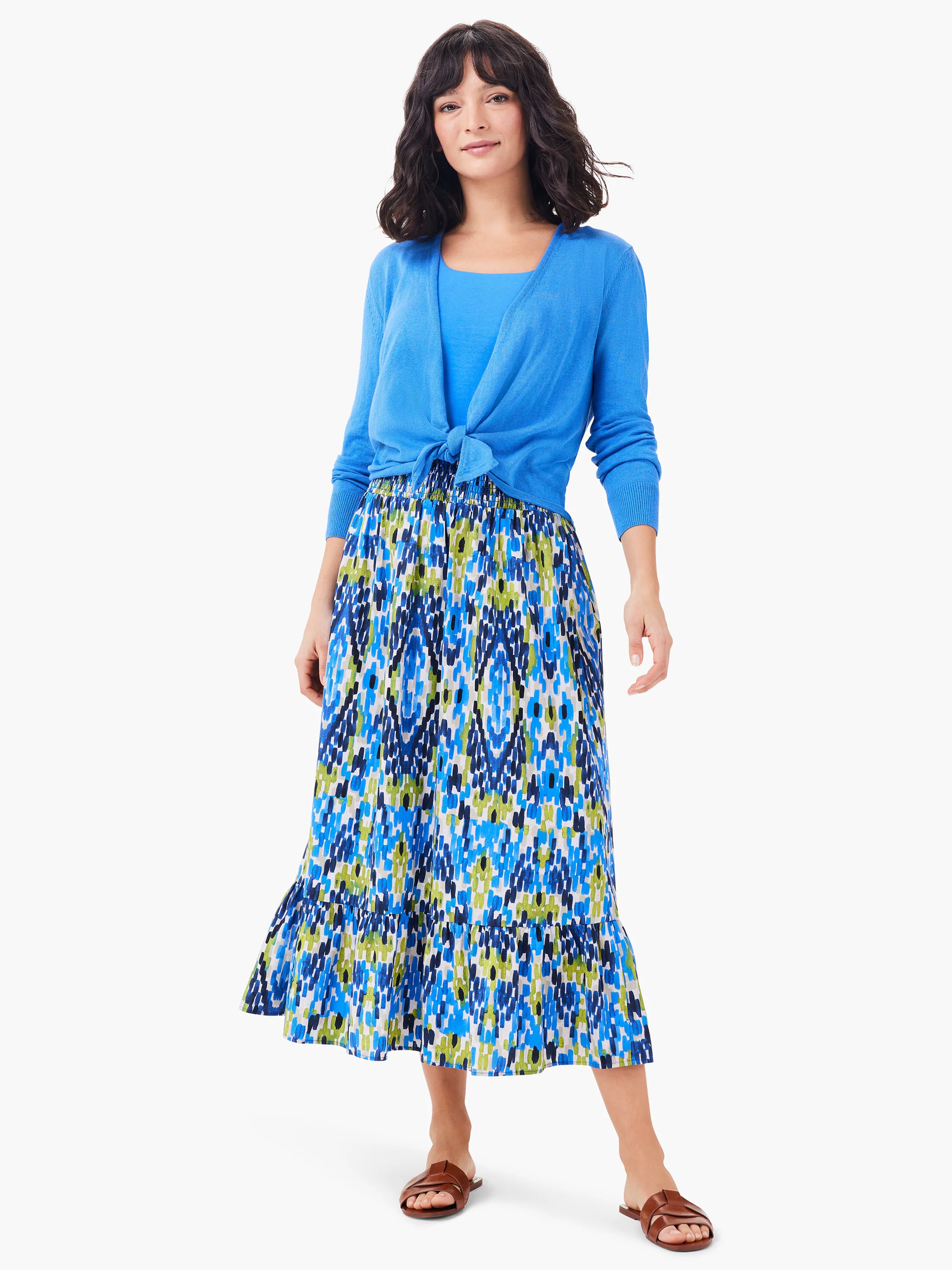 Mid-length skirt with blue, green, and white abstract print. Features a ruffled hem.