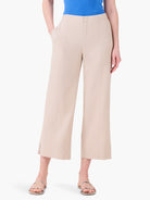 Light beige wide-leg crop pants feature vertical front seams, side pockets, and fall above the ankle.