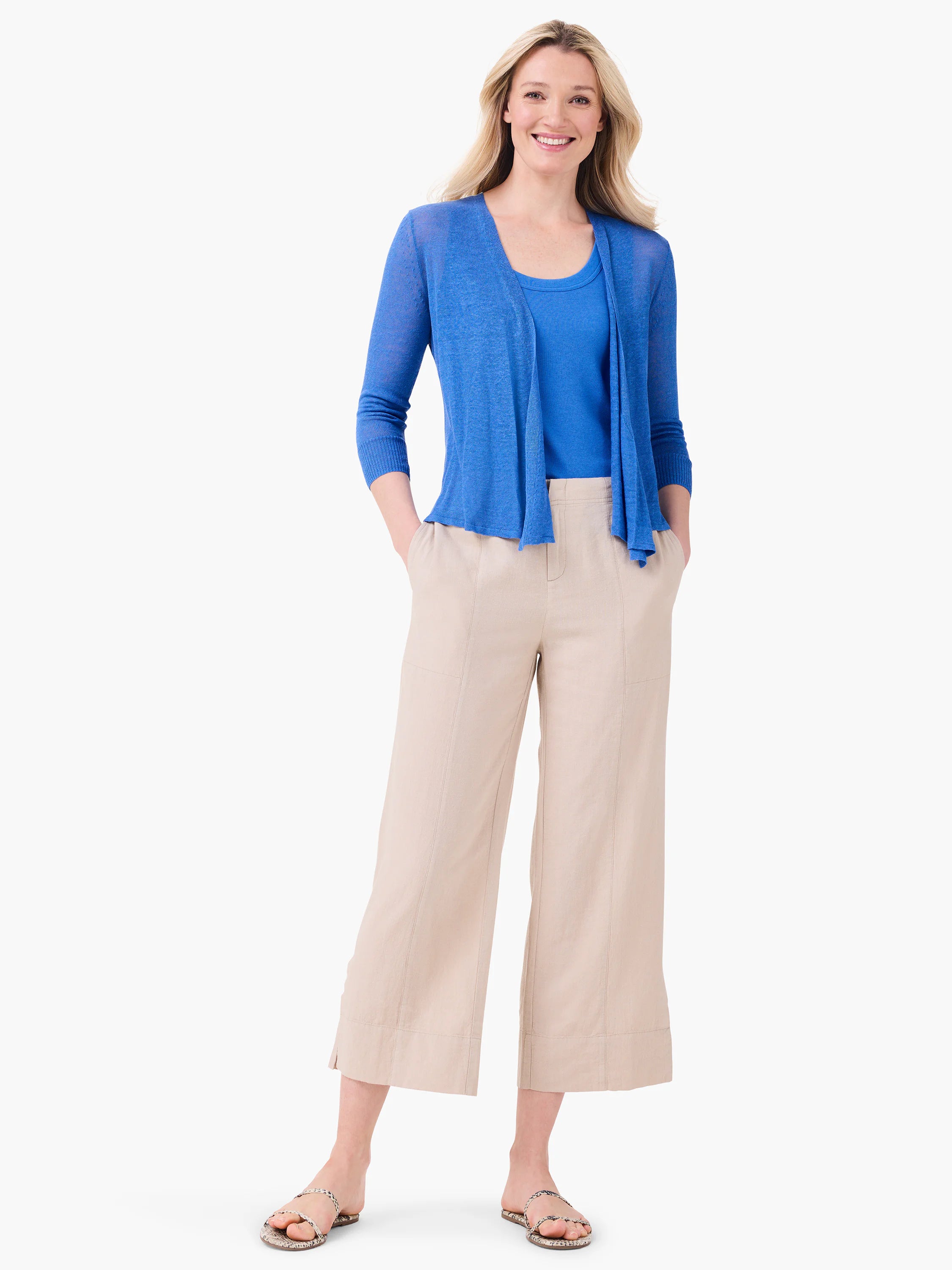 Light beige wide-leg crop pants featuring front seams and a textured, relaxed fit.