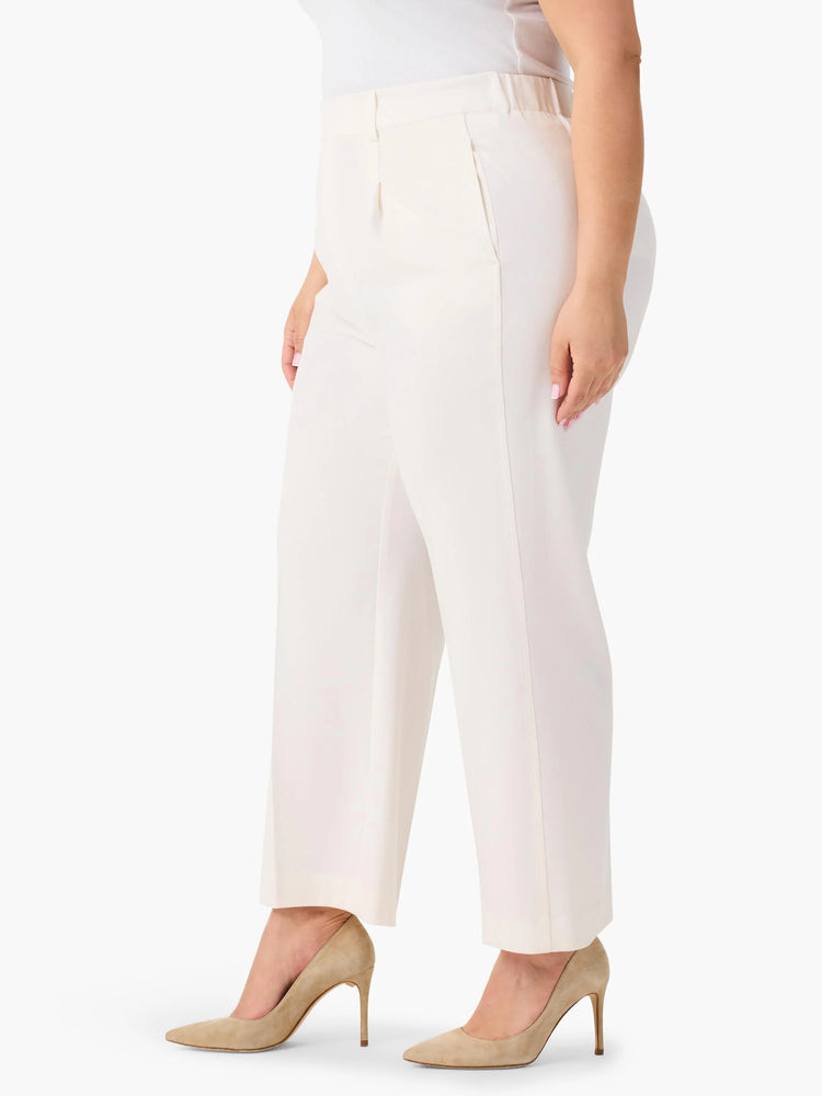 Off-white wide-leg cropped trousers; model wears nude heels.