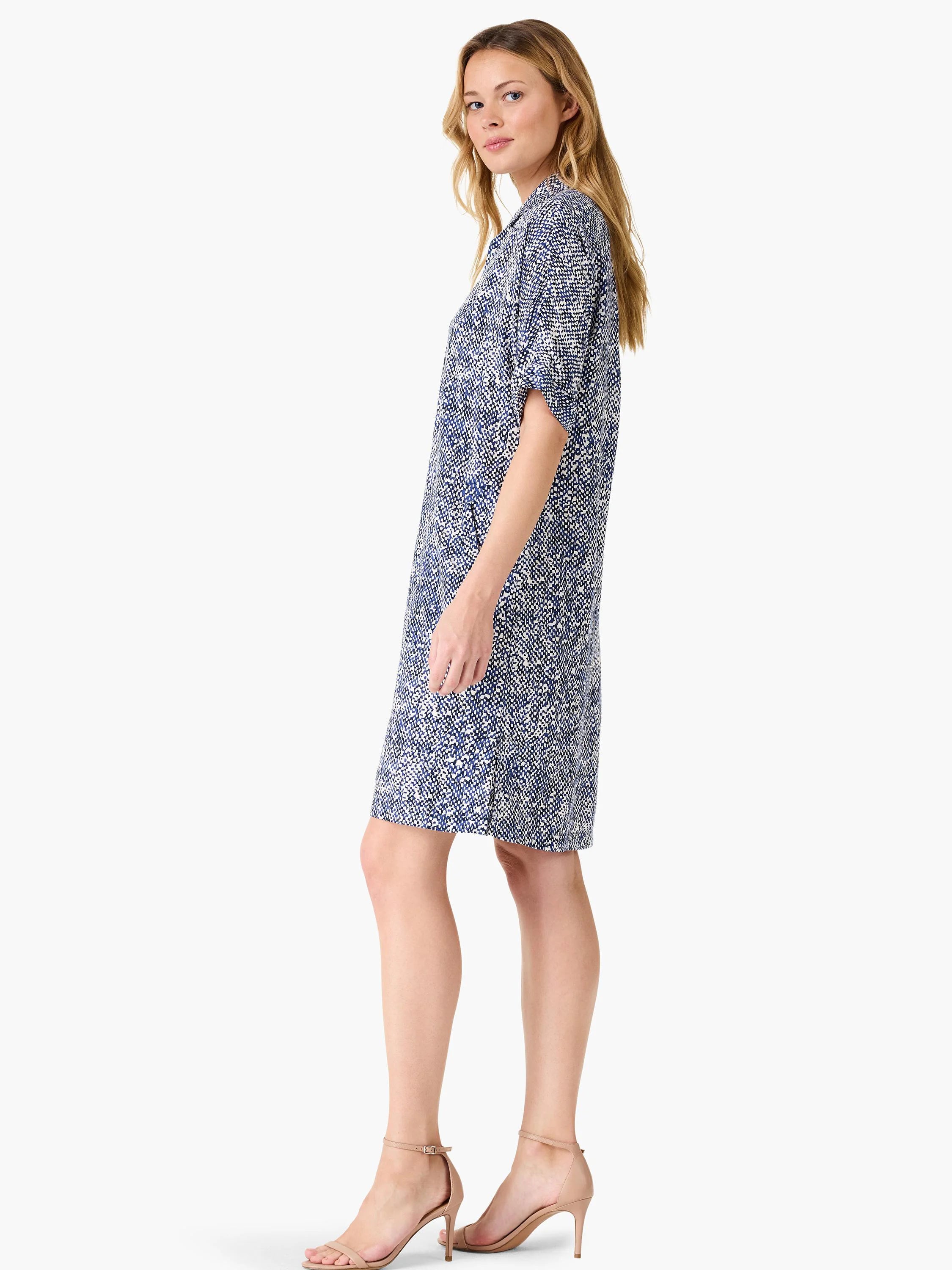 Short, collared dress in navy blue and white speckled pattern. Short sleeves, knee-length.