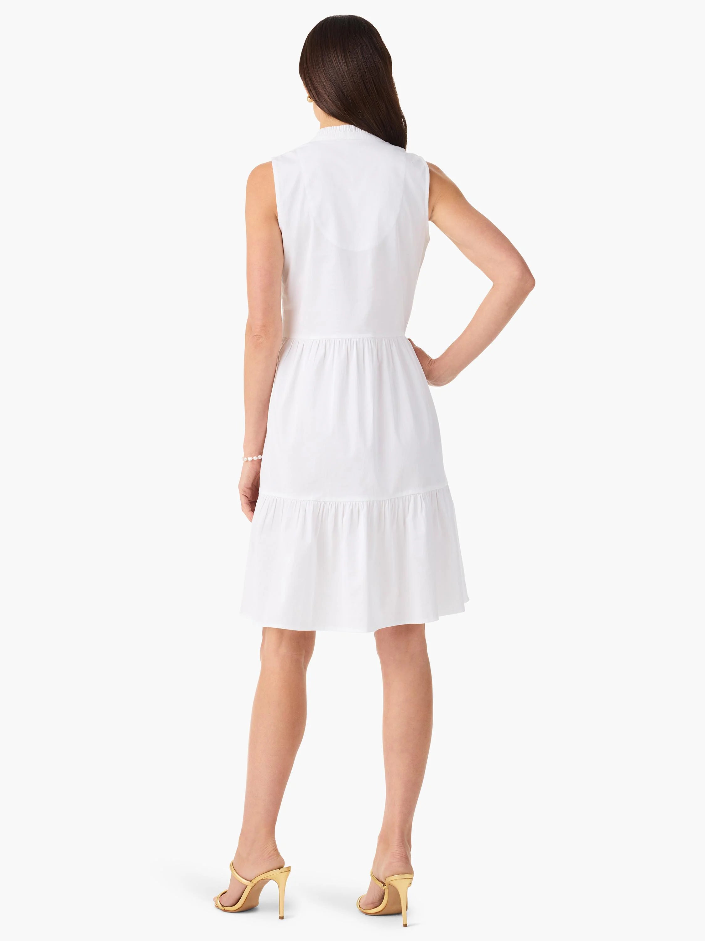 White sleeveless tiered mini dress, collared neckline.  Shown from the back.