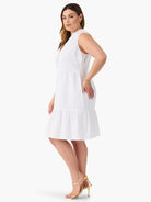 White sleeveless tiered dress with button front.  The hemline is slightly above the knee.