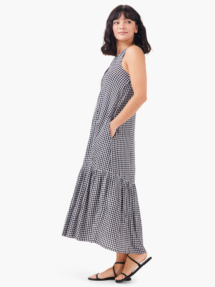 Black and white gingham sleeveless maxi dress with a ruffled hem and pockets.