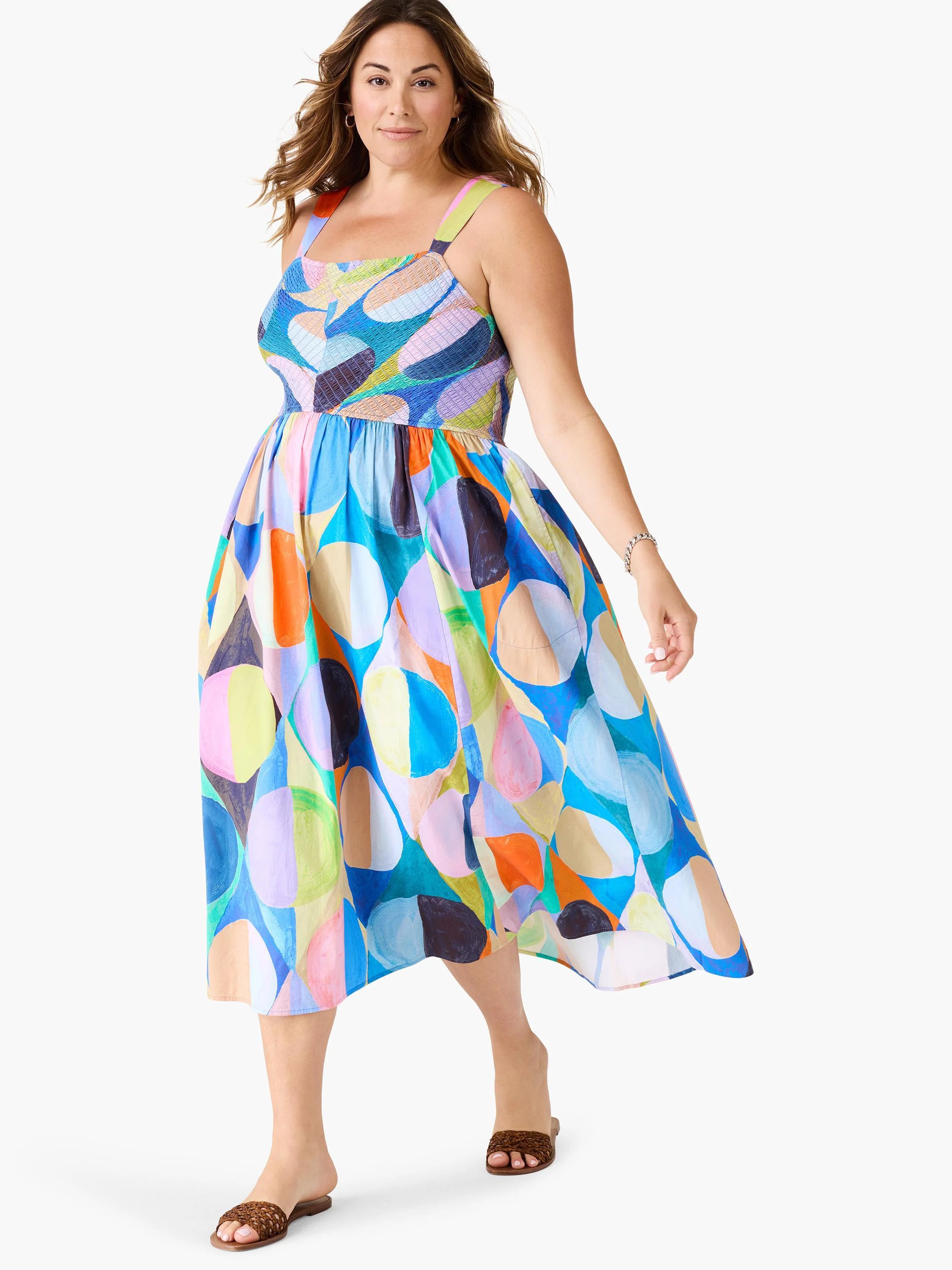 Midi dress, sleeveless, square neck. Abstract print in blue, orange, purple, green, and beige. A-line silhouette.