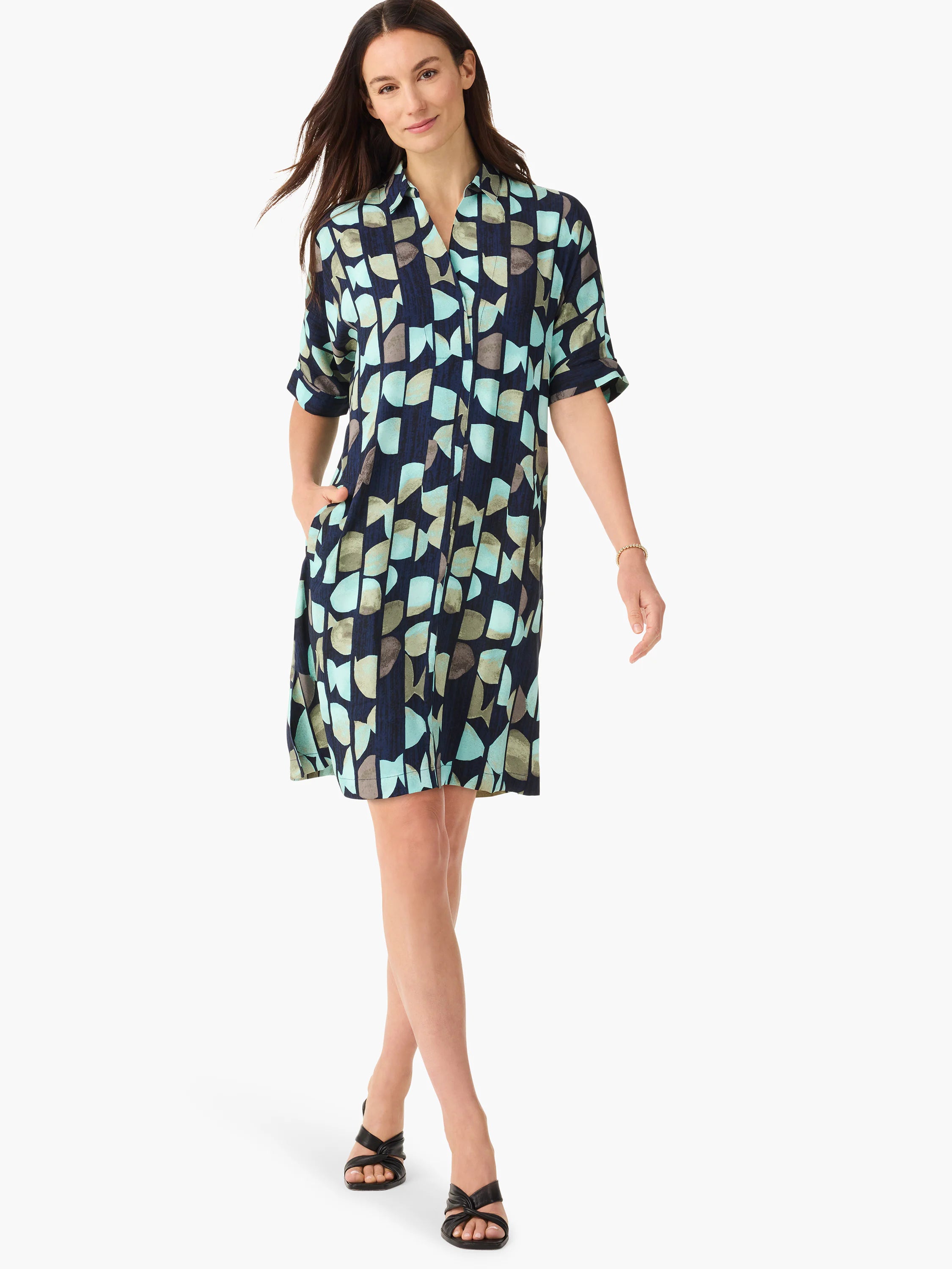 Navy blue shirt dress, teal and gray abstract print, short sleeves, collared neckline, knee-length. Has pockets.