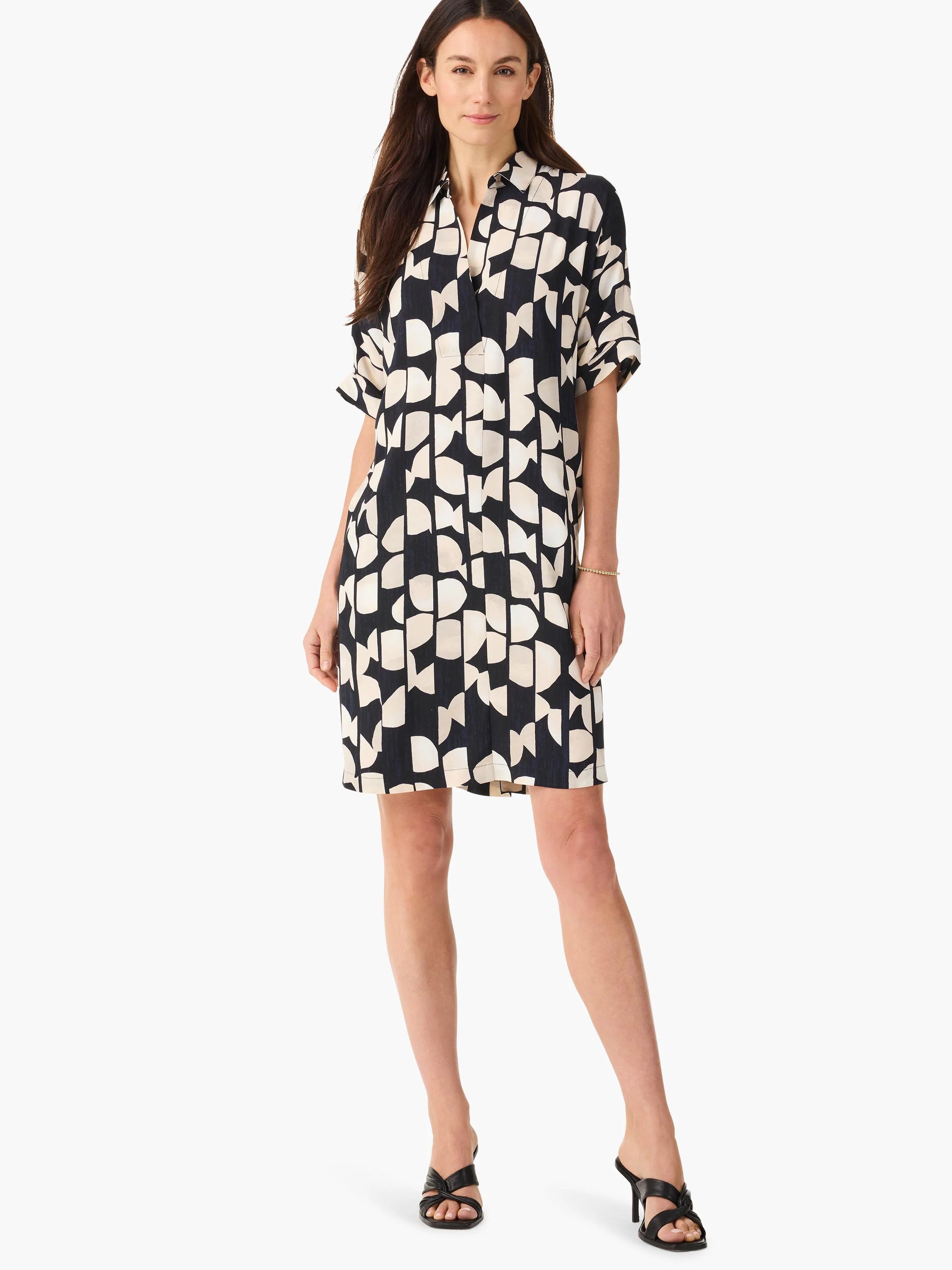 Black short-sleeved shirt dress with an abstract beige and black pattern.