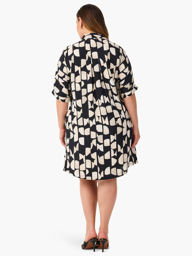 Black short-sleeved shirt dress with beige abstract print. Back view.