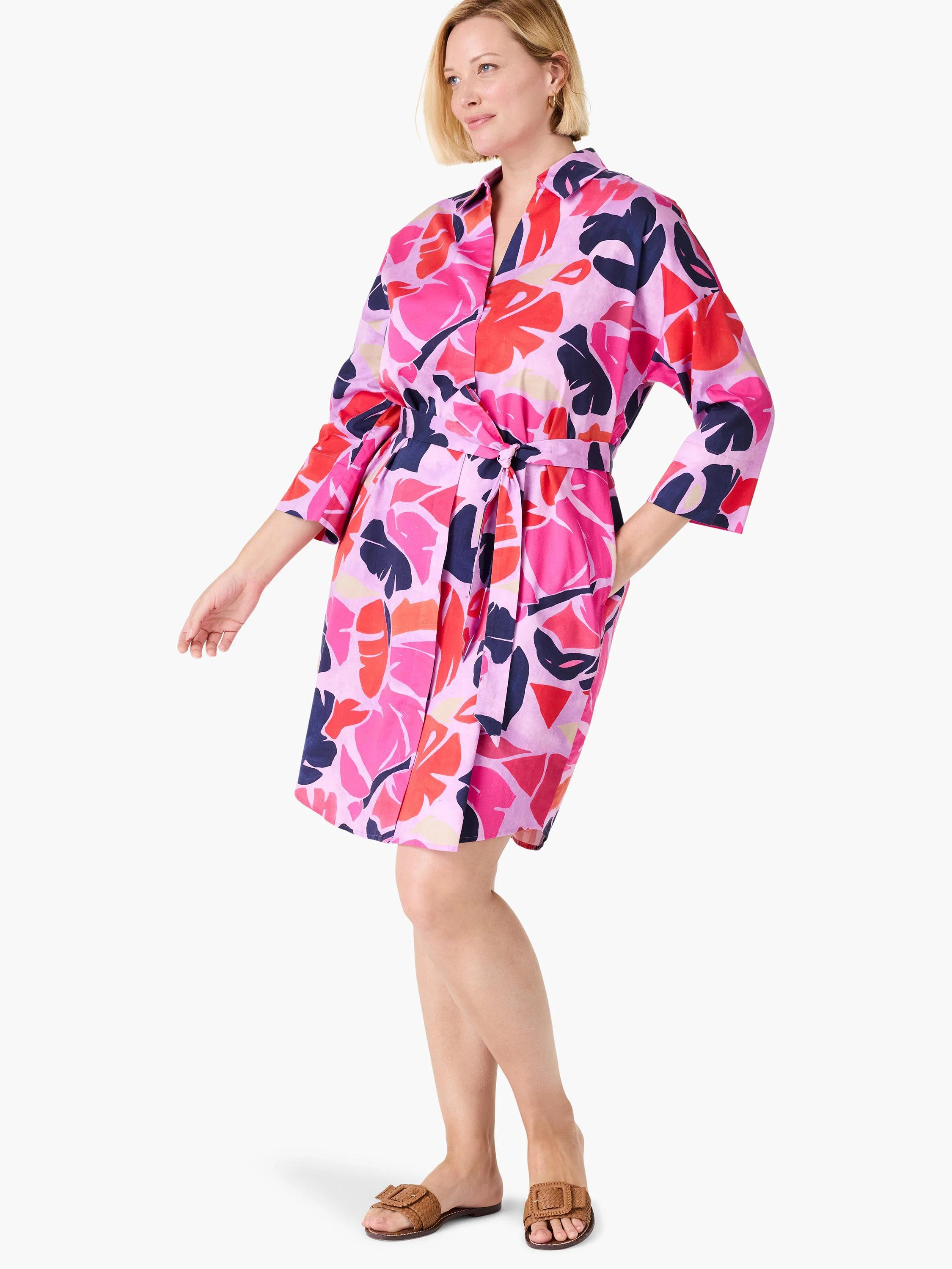 Lilac dress with pink, red, and navy blue abstract leaf print. Three-quarter sleeves, belted waist, and pockets.